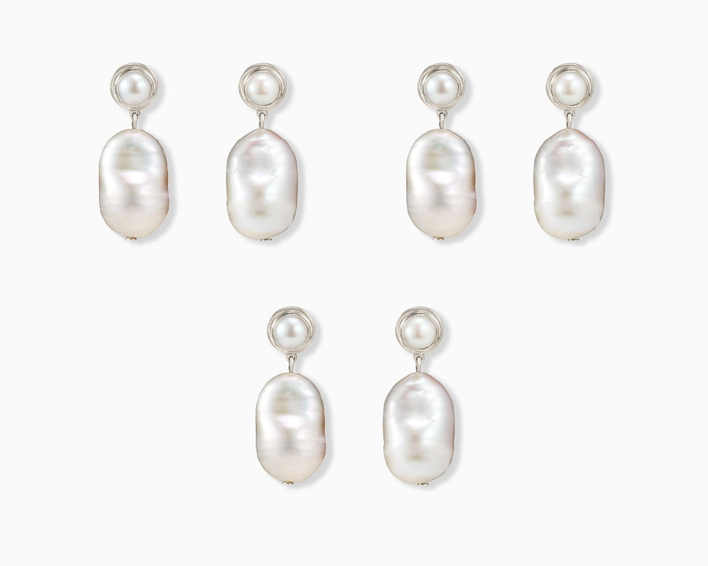 Three pairs of AGMES .925 sterling silver and baroque freshwater pearl Delphine earrings. On white background.