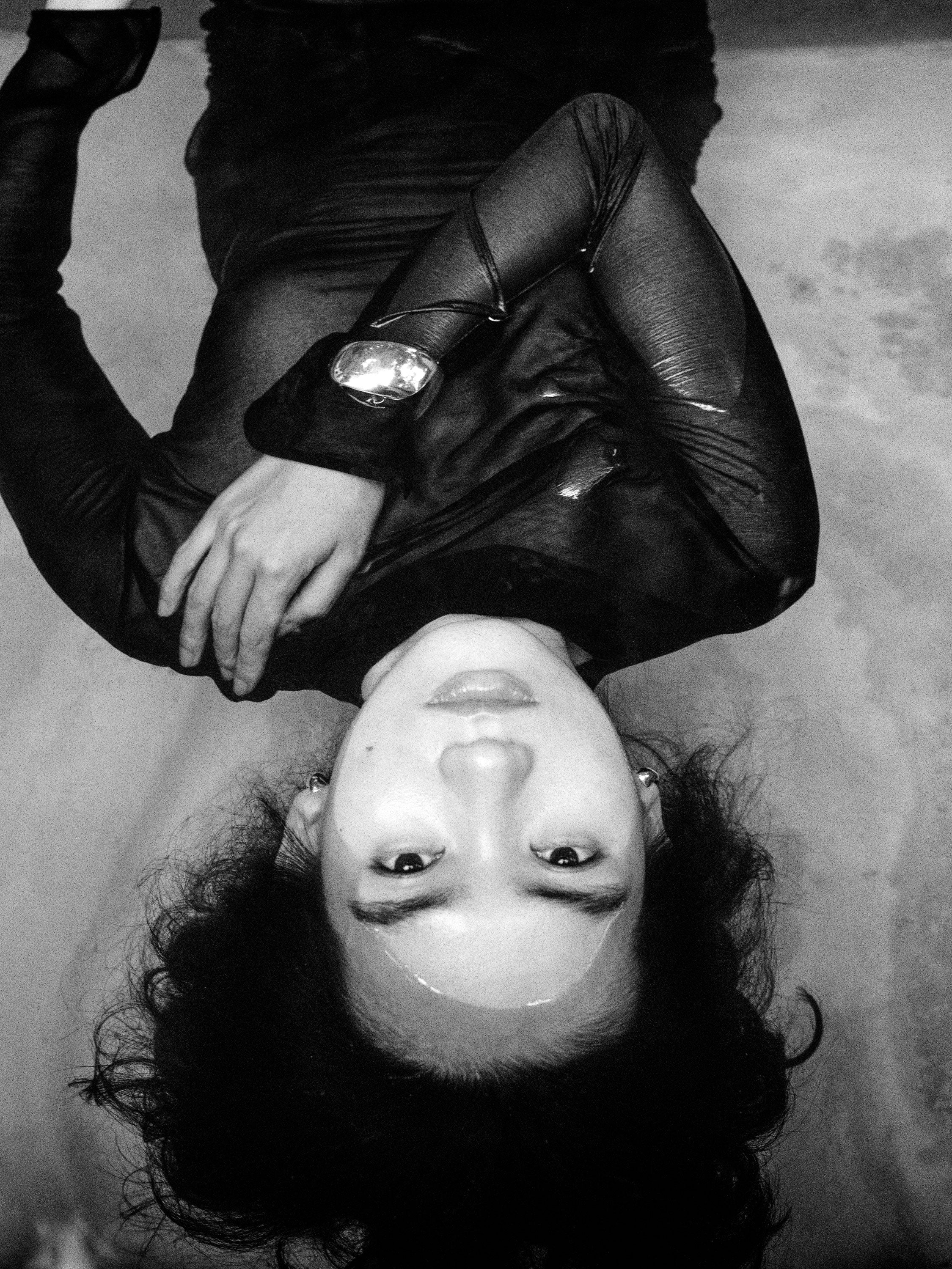 Woman submerged in water wearing black dress and AGMES 0.925 sterling silver sculpted Cecil cuff bracelet.