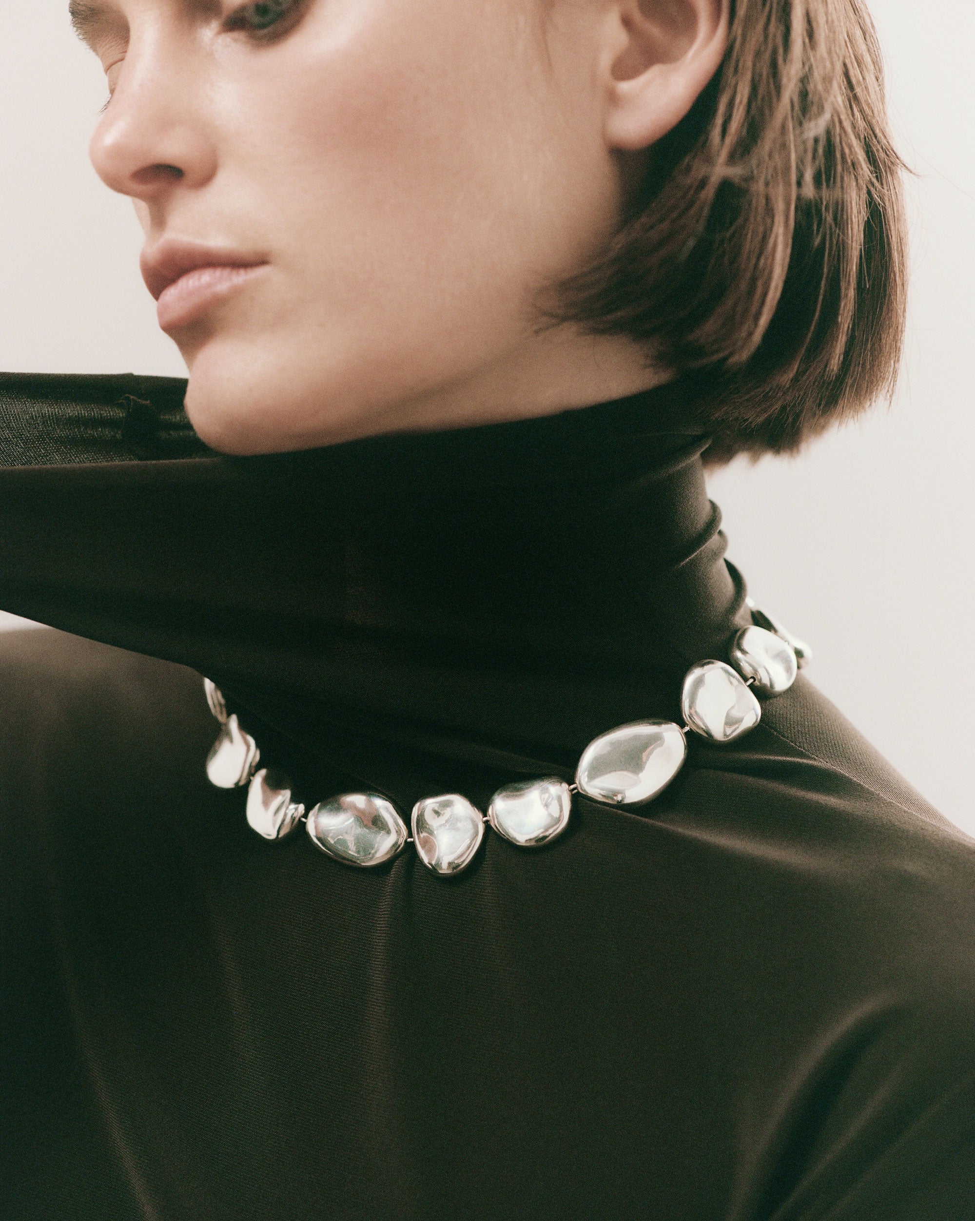 Woman wearing AGMES .925 Sterling Silver Conie sculpted round Necklace with T-Bar Clasp.