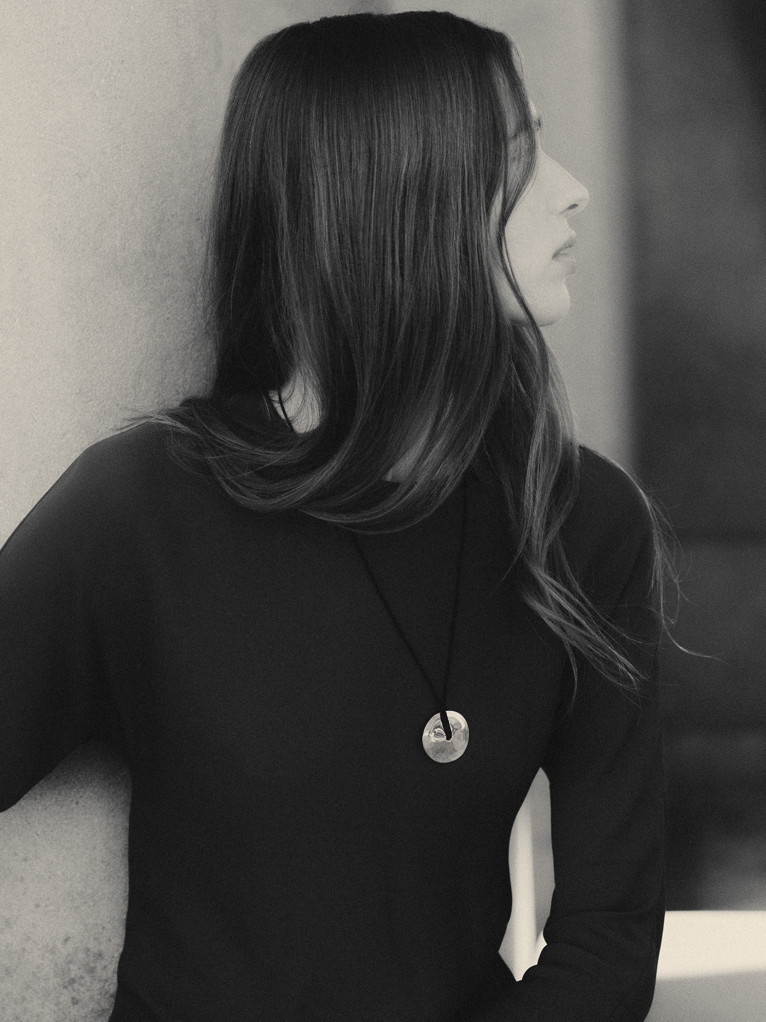 Woman wearing AGMES 0.925 Sterling Silver Cora Pendant paired with Black Suede Cord. Round Pendant Self-Tie Necklace.