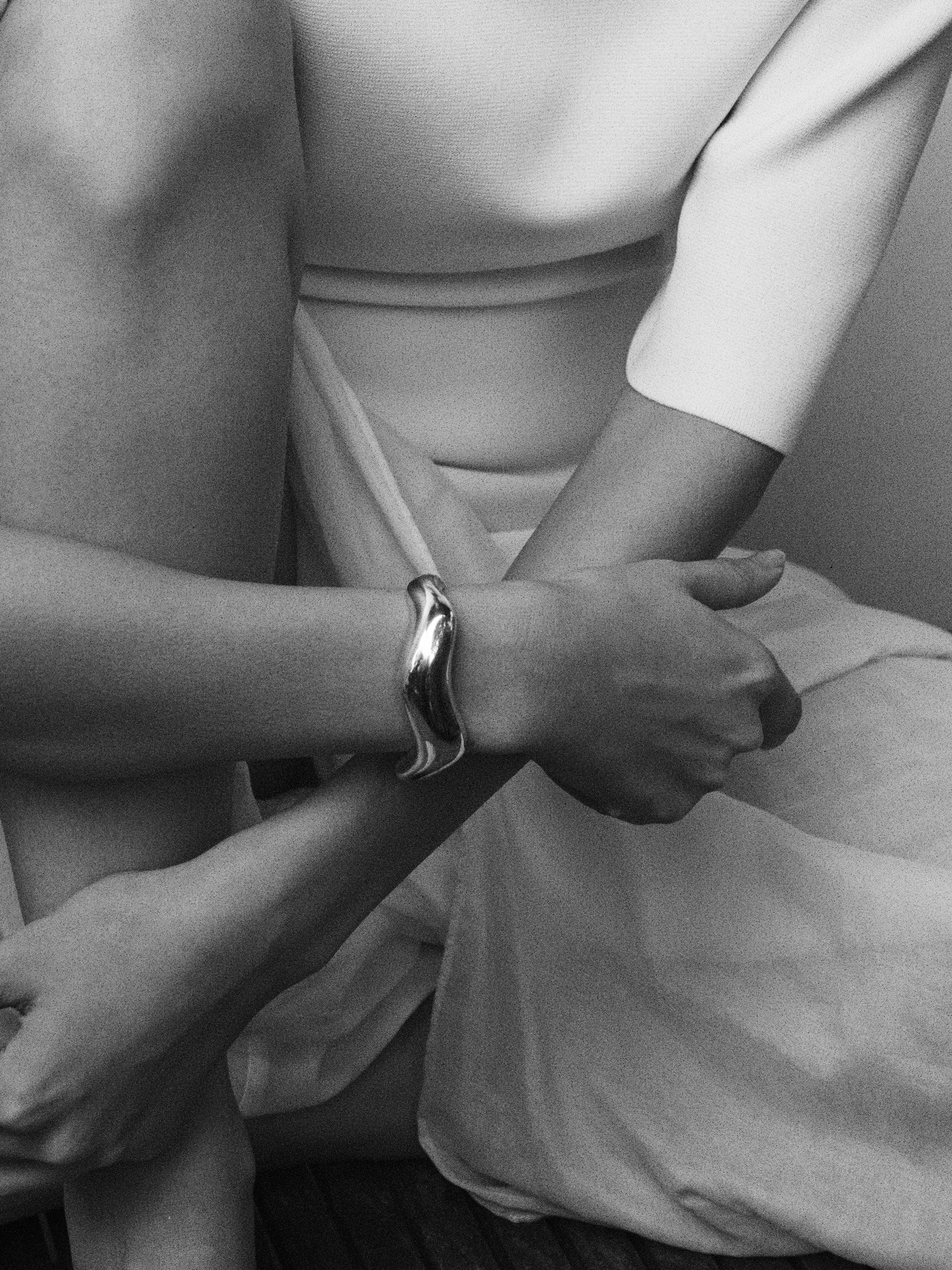 AGMES 0.925 sterling silver sculpted large Astrid cuff on woman's wrist.