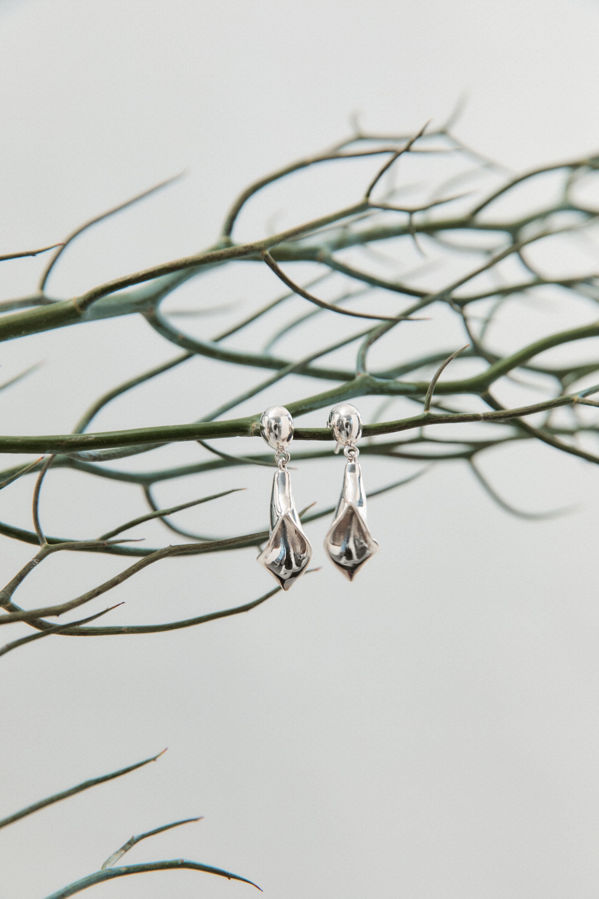 AGMES 0.925 sterling silver mini calla lily inspired drop earrings.