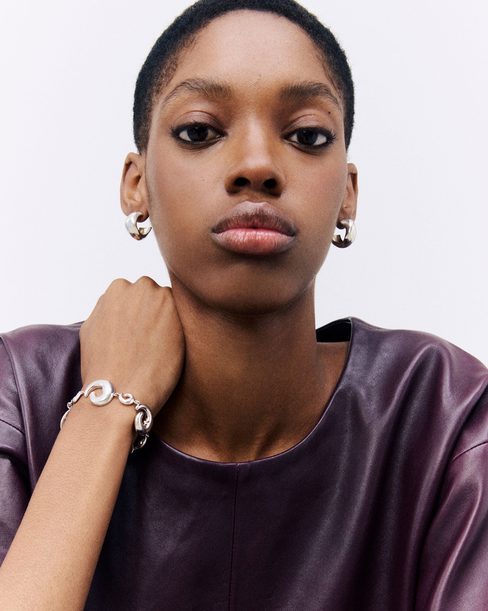 Model wearing AGMES .925 Sterling Silver Fredrika Bracelet and Small Celia Hoops