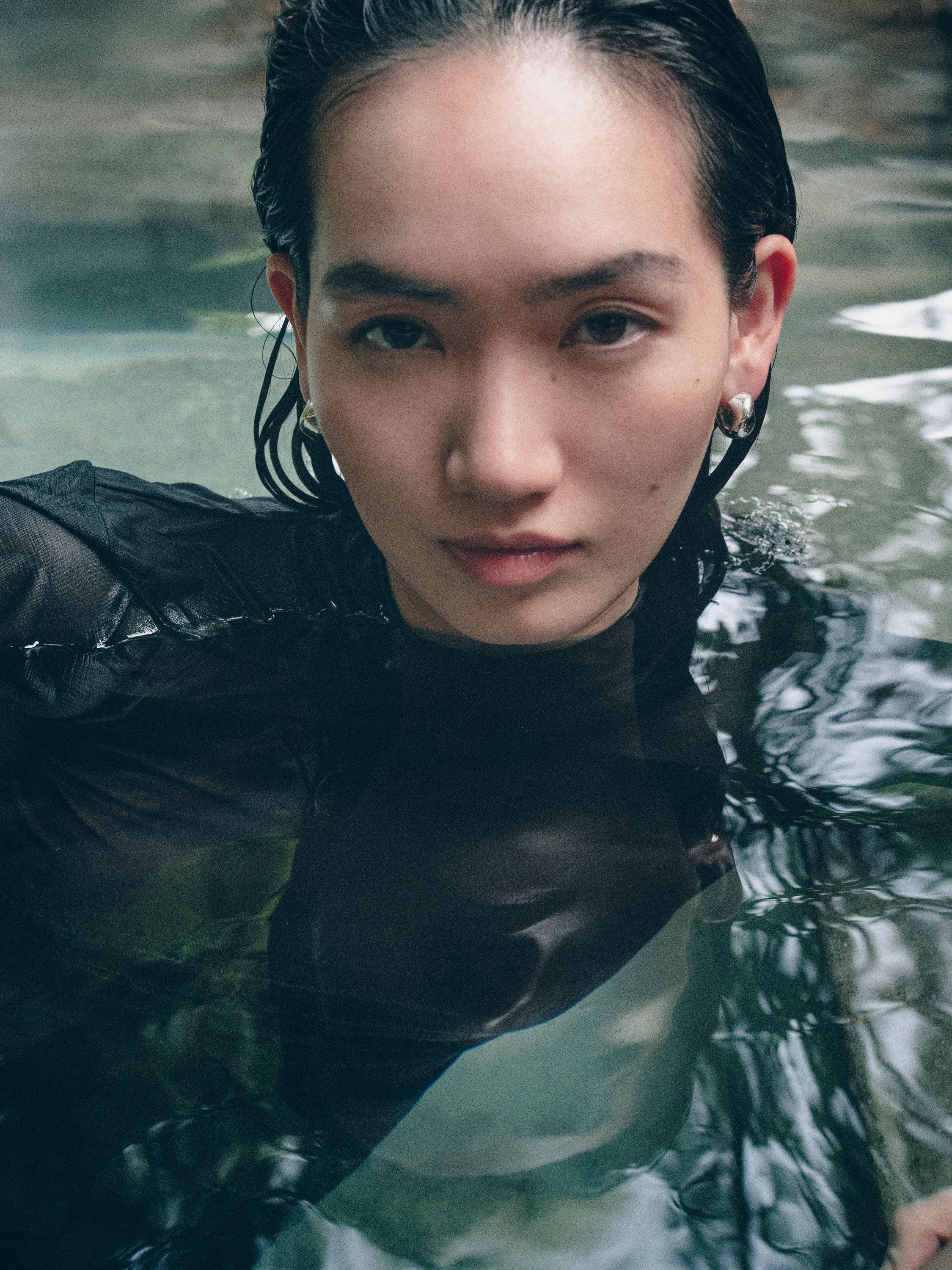 Person wearing AGMES 0.925 sterling silver small hoop earrings.