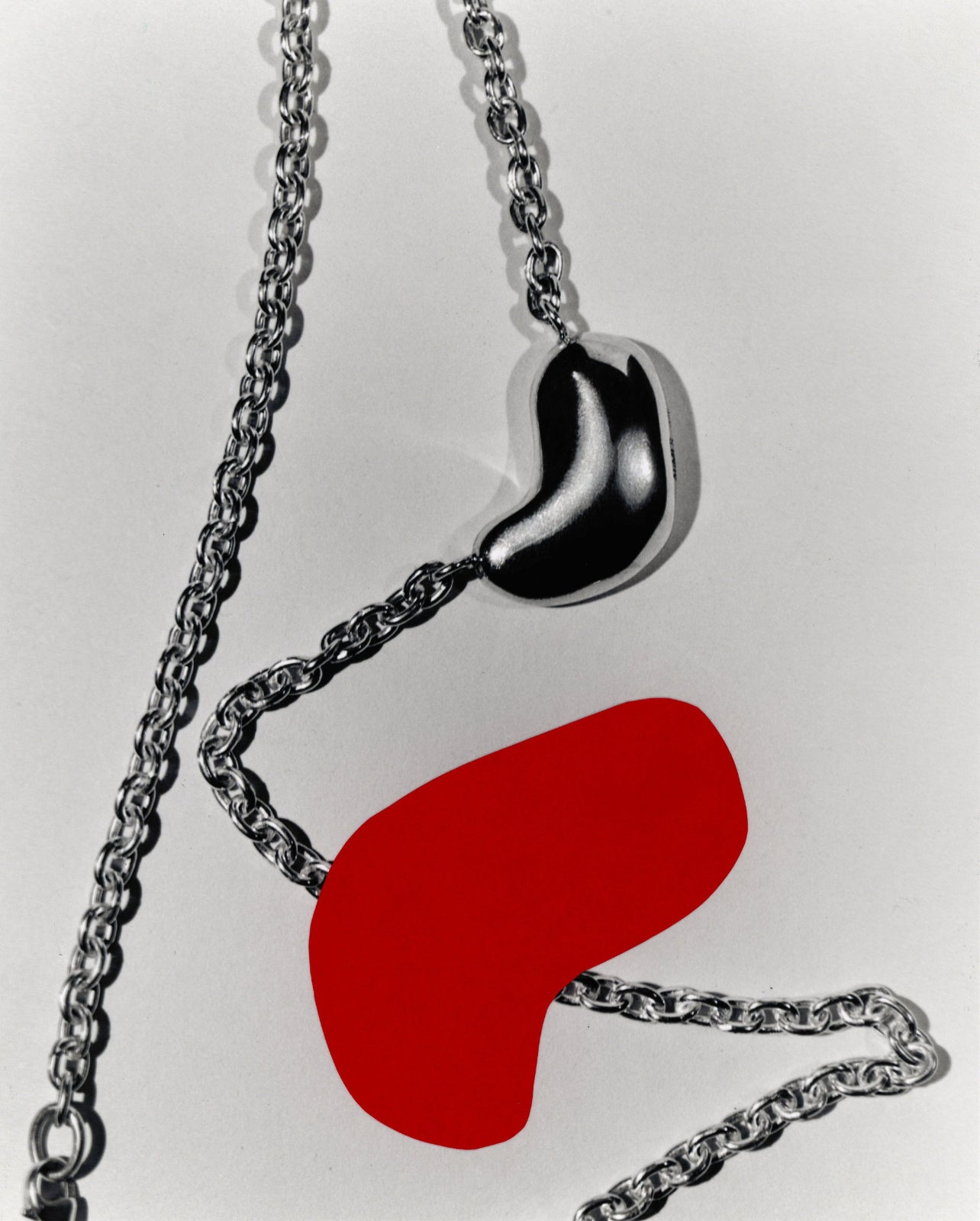AGMES .925 Sterling Silver Small Sculpted Heart Pendant II on chain necklace with red heart graphic.