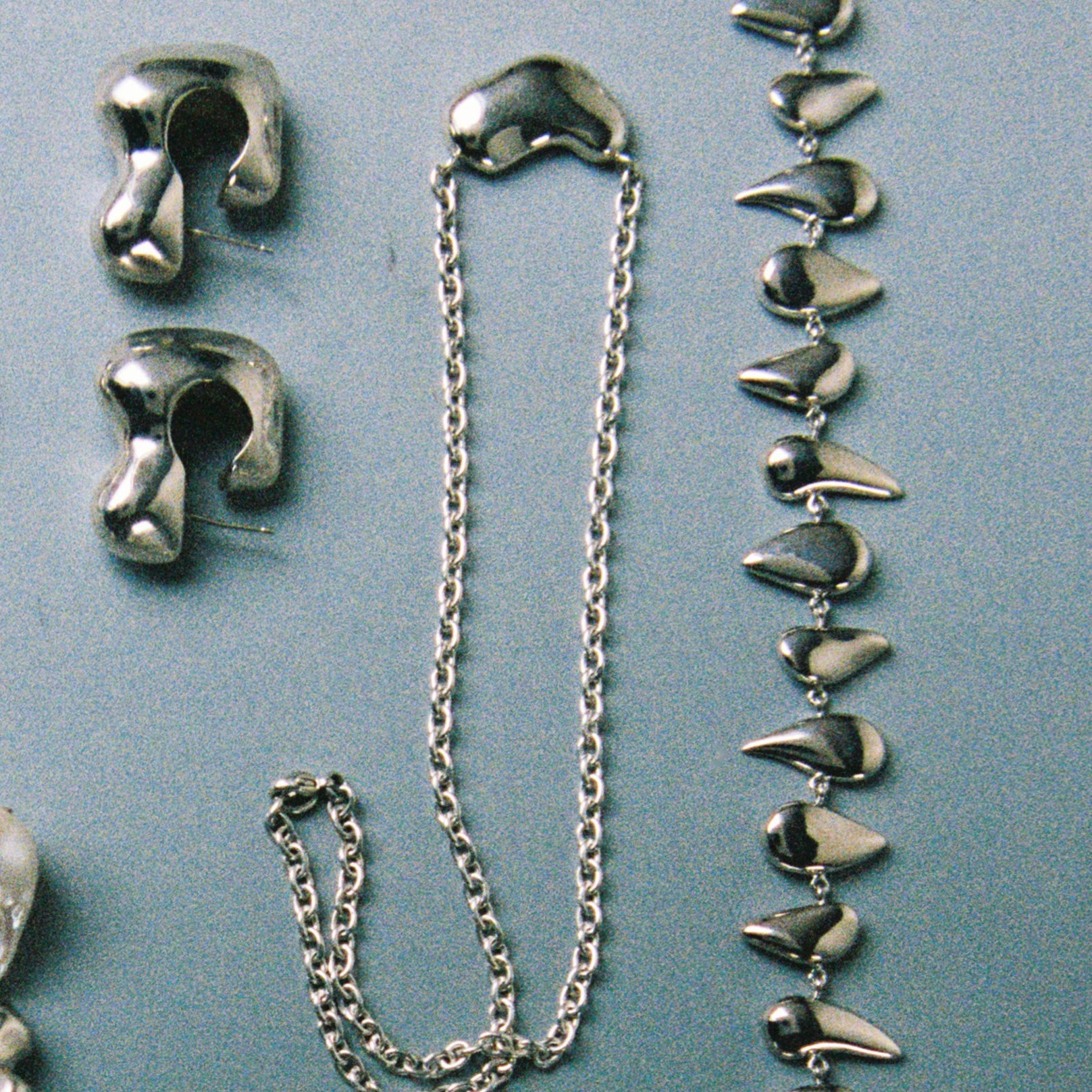 AGMES .925 Sterling Silver Small Sculpted Heart Pendant II on chain necklace. Displayed alongside Flora necklace and Bubble Hoops.