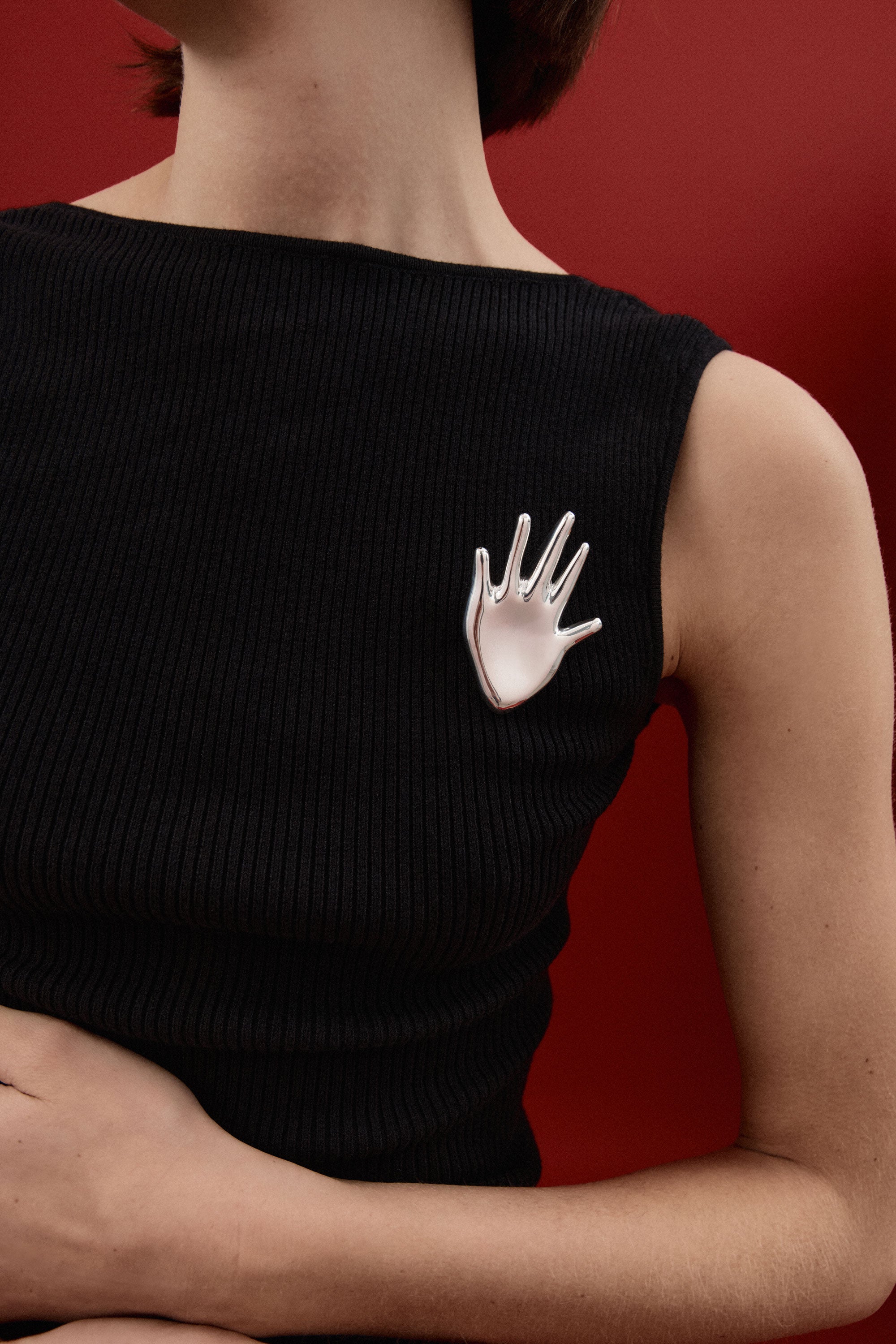 Person wearing AGMES .925 Sterling Silver Large Dali Brooch on black shirt. Hand shaped Brooch.