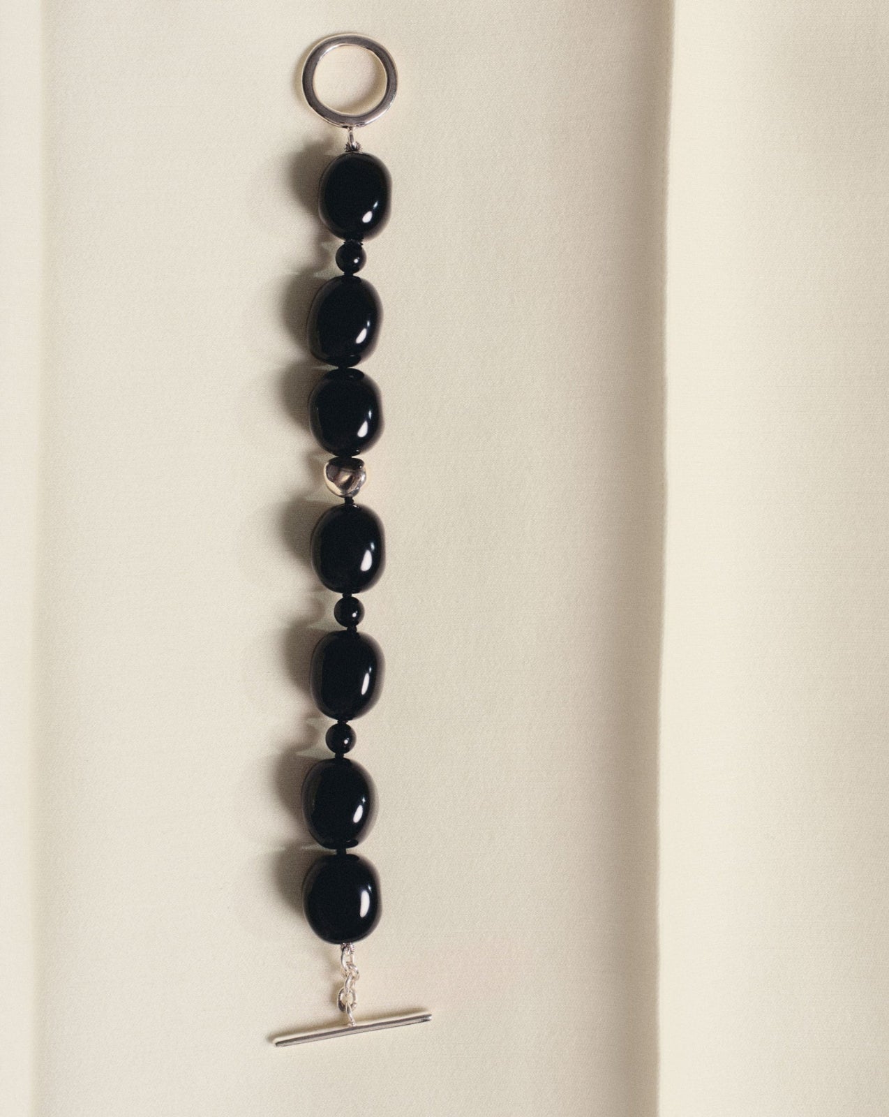 Black onyx beaded bracelet with .925 sterling silver accent on off-white background