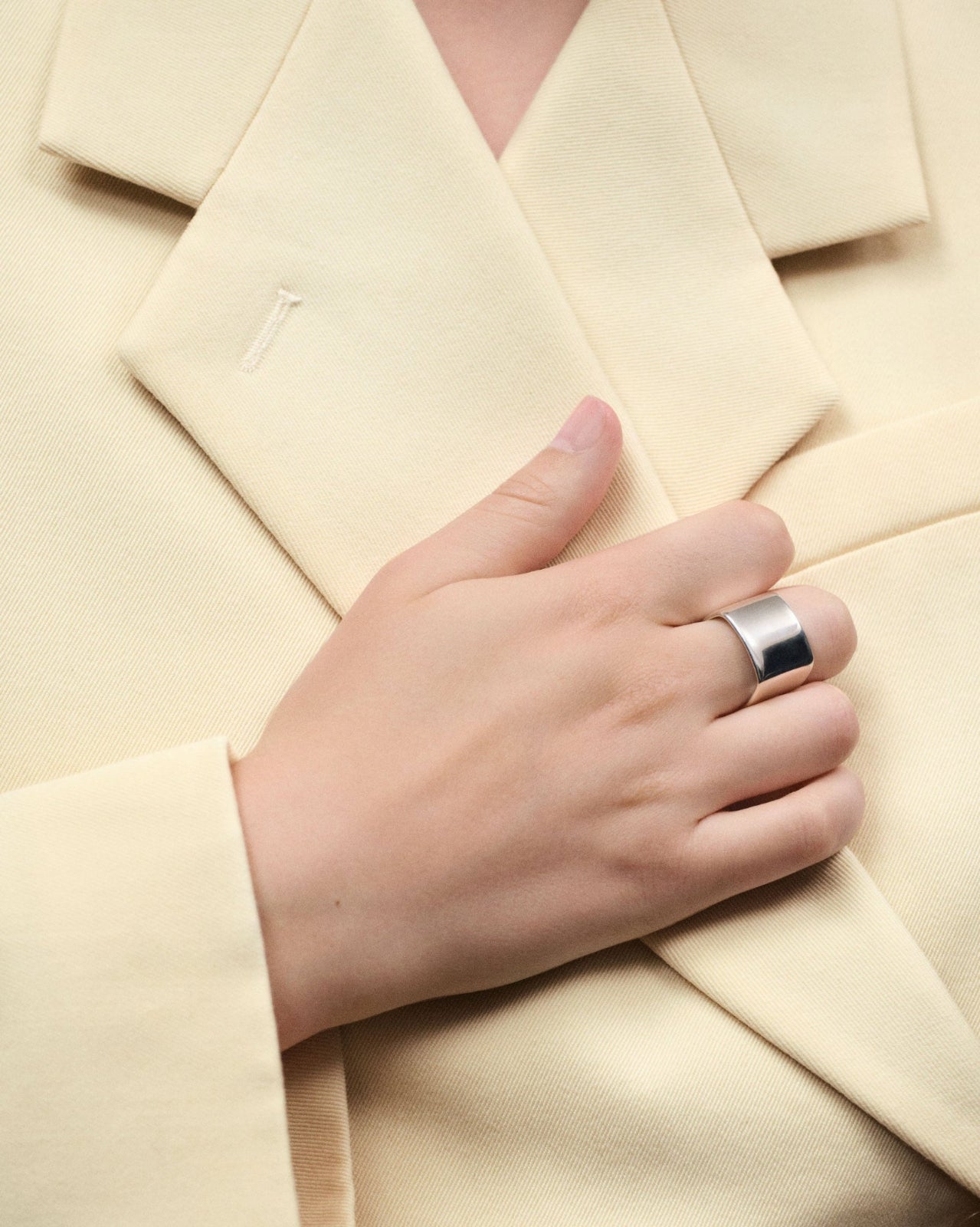 Hand wearing AGMES 0.925 Sterling Silver wide Daria Ring.