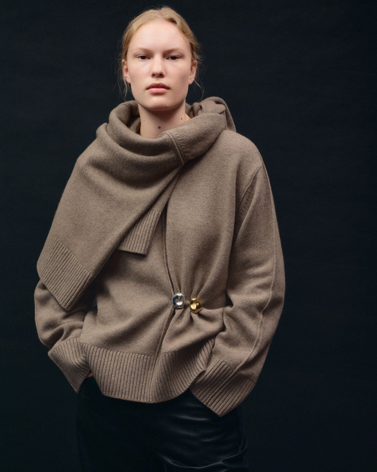 Model wearing AGMES .925 sterling silver and 18k gold vermeil sculptural round Gia Brooches on oversized tan sweater.