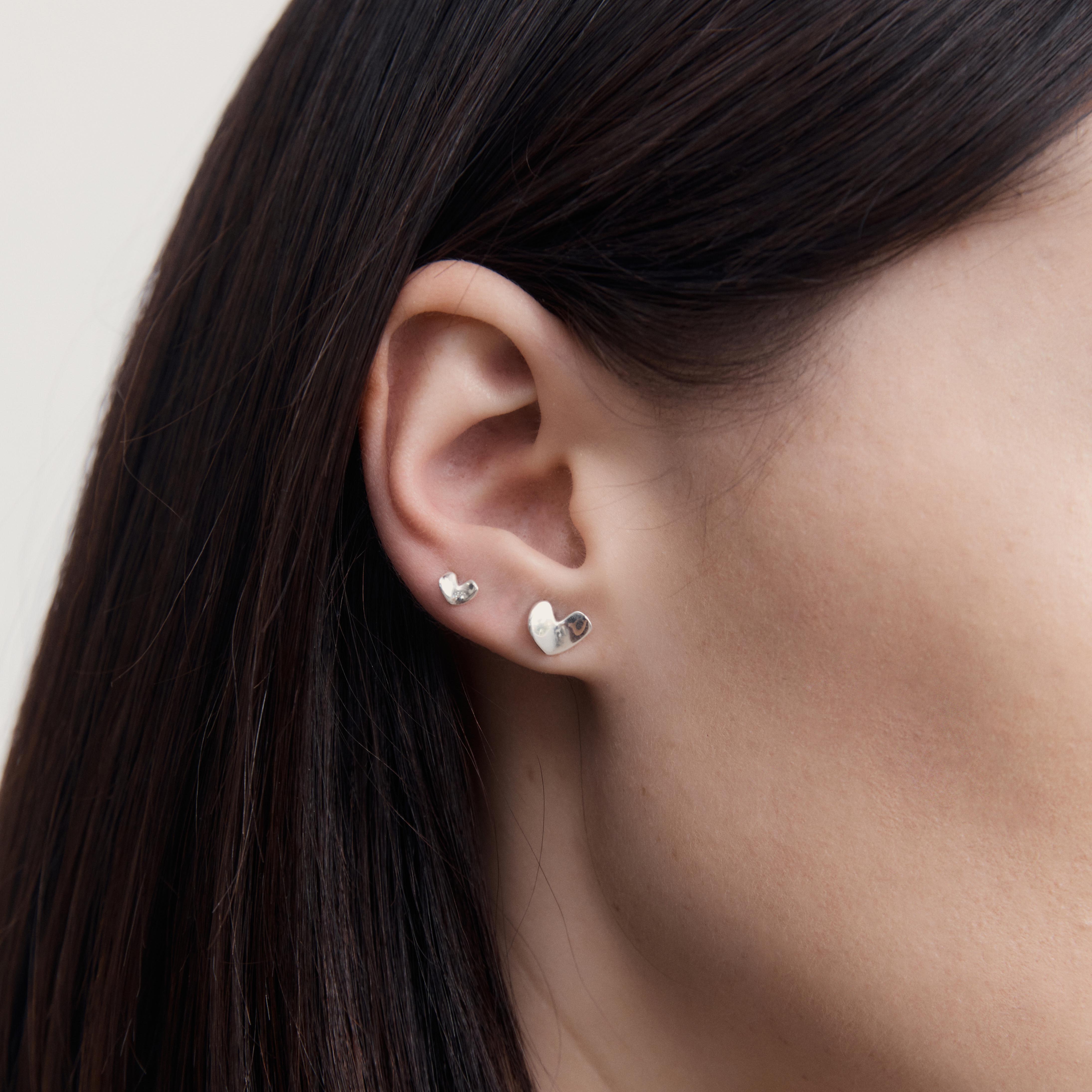 AGMES 0.925 sterling silver sculpted heart stud earrings.