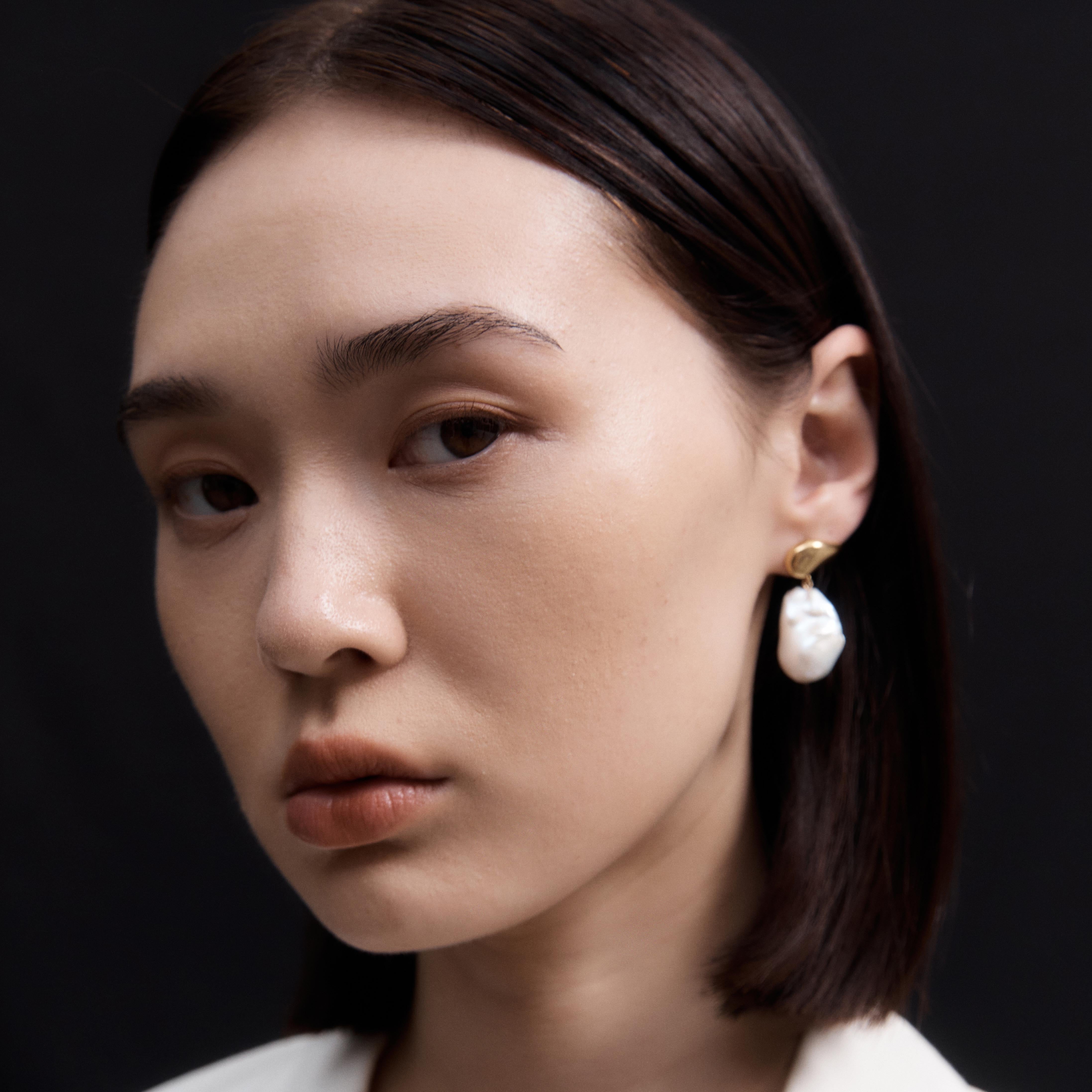 Woman wearing AGMES 18K Gold Vermeil Ila Earrings with Baroque Pearl Drop.