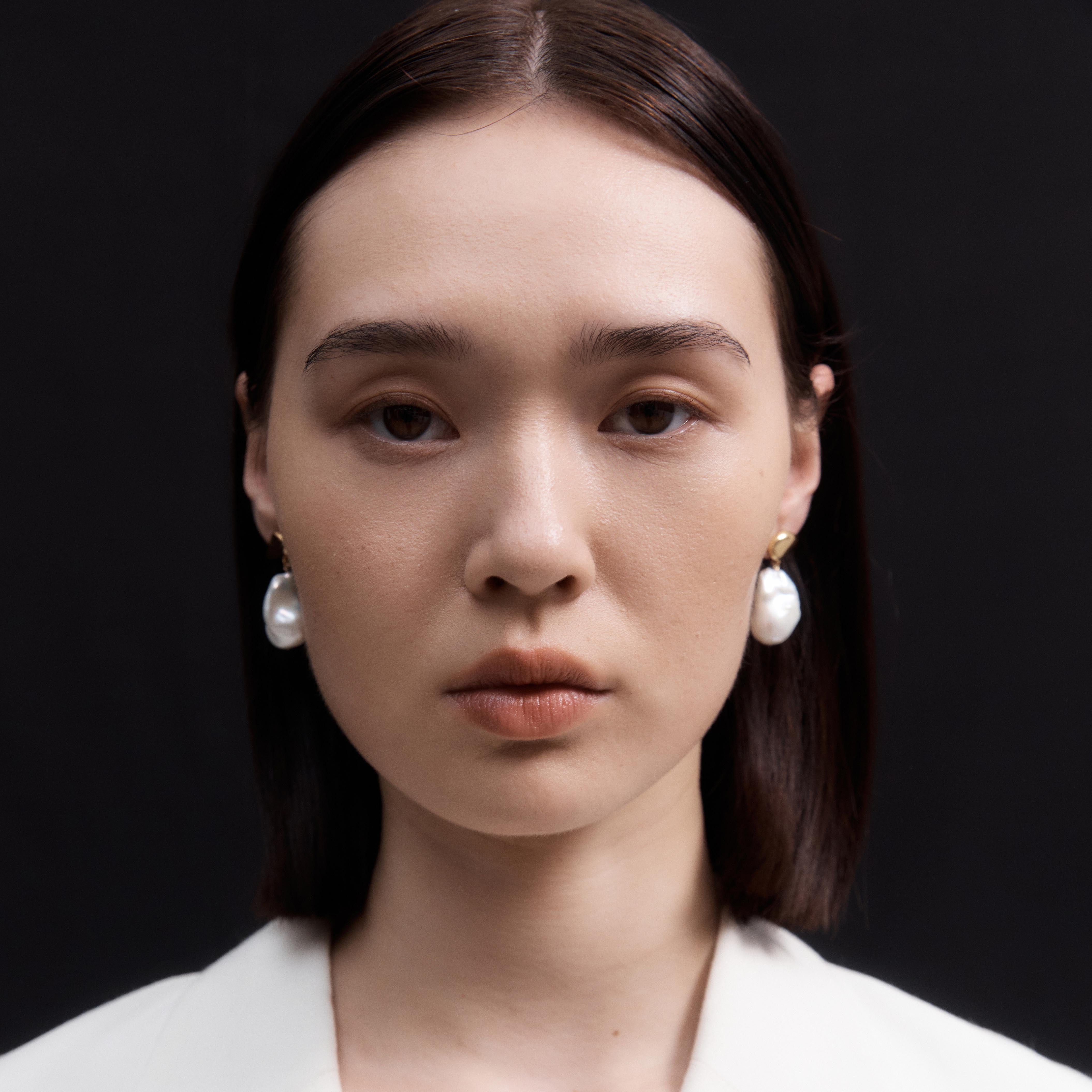 Woman wearing AGMES 18K Gold Vermeil Ila Earrings with Baroque Pearl Drop.