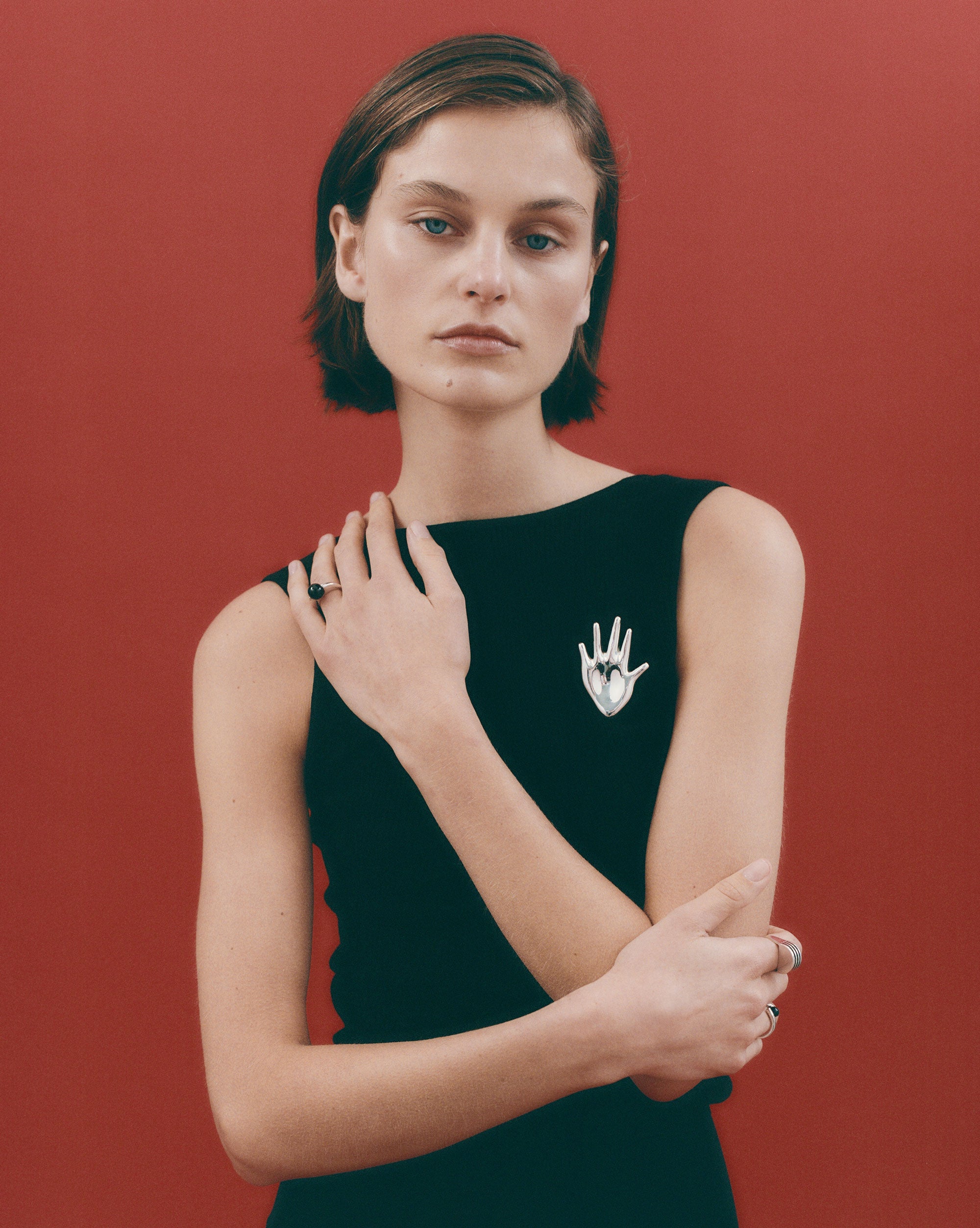 Woman wearing the AGMES .925 Sterling Silver Large Dali Brooch and Chloe Ring. Hand shaped Brooch.