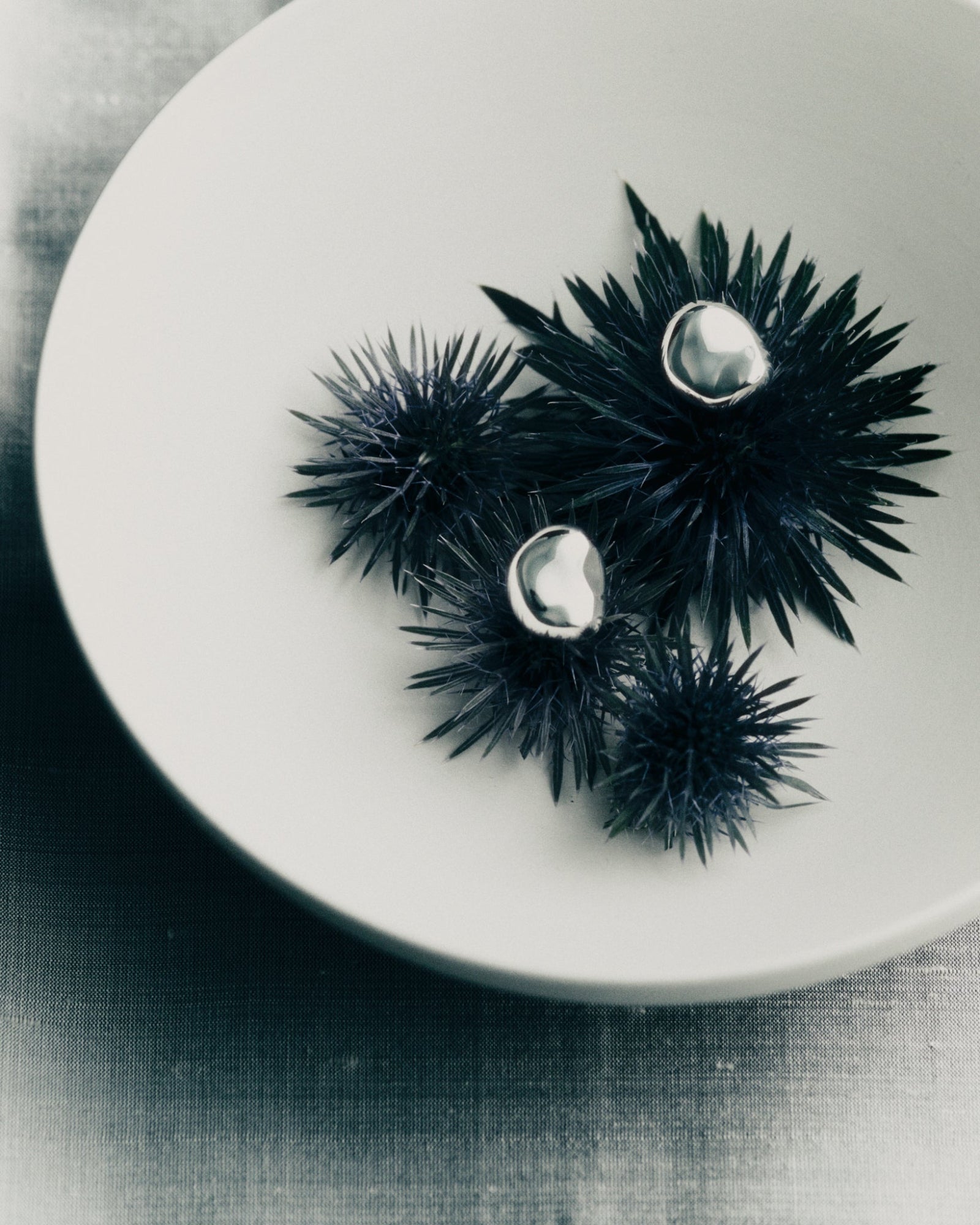 AGMES 0.925 sterling silver sculpted round stud earrings.