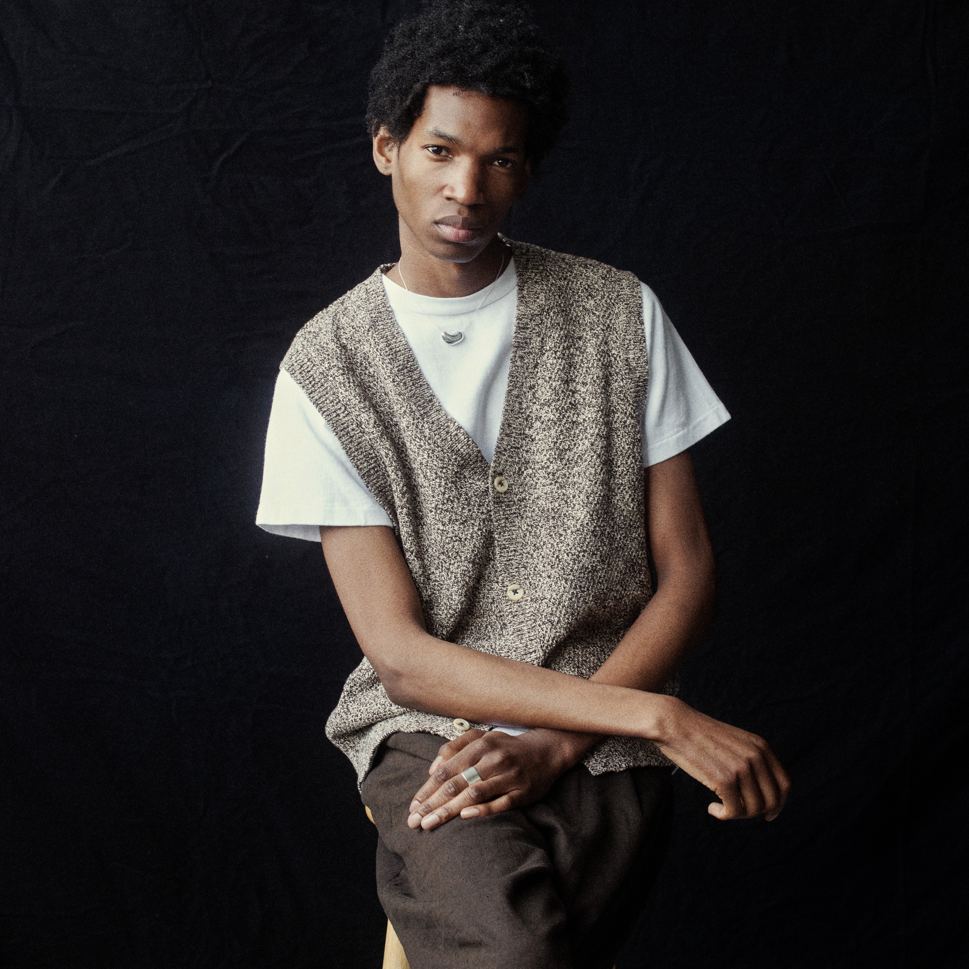 Man wearing AGMES .925 Sterling Silver Small Sculpted Heart Pendant.