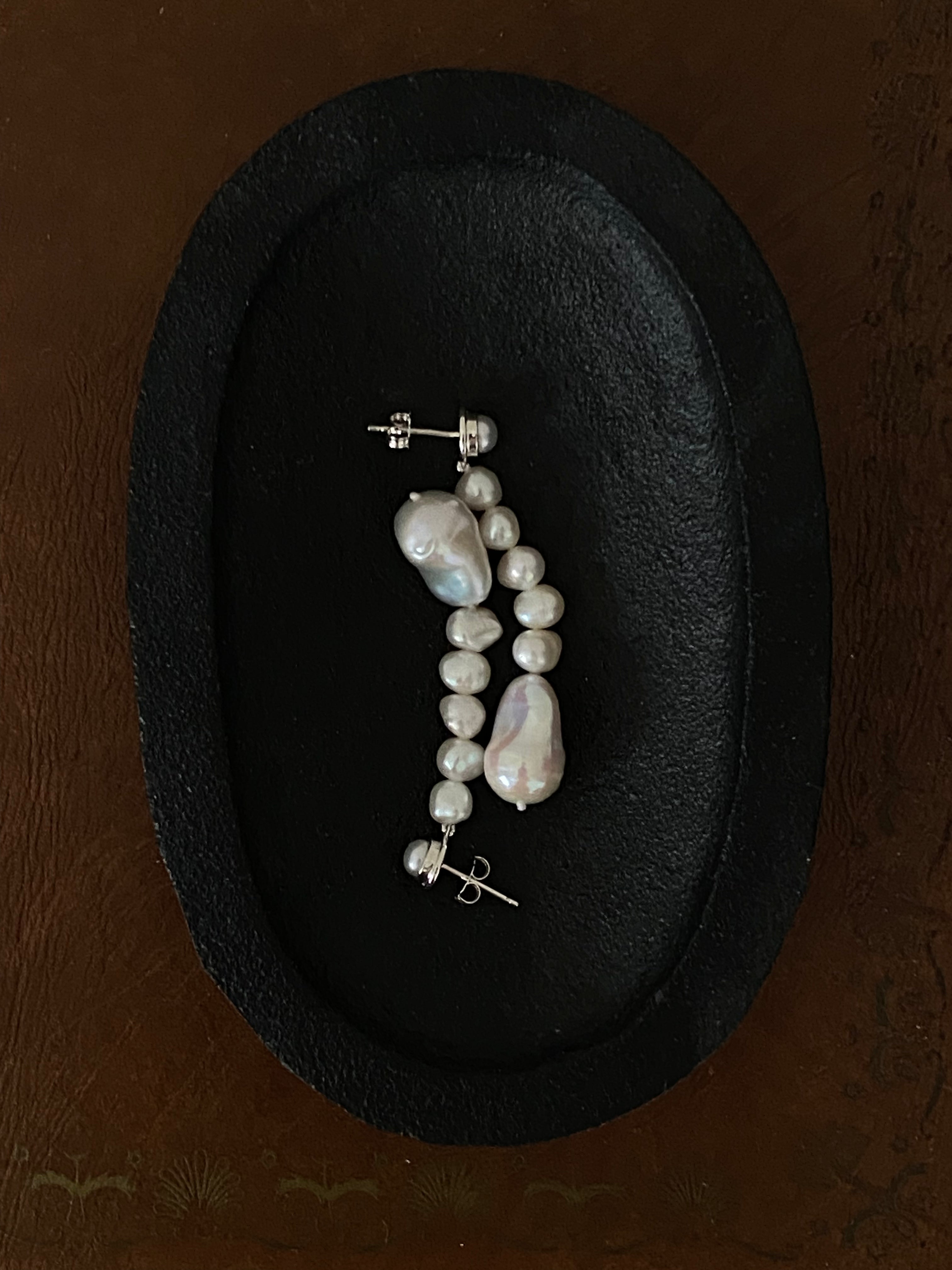 AGMES Emmanuelle pearl drop earrings 0.925 sterling silver displayed in black bowl on brown background.