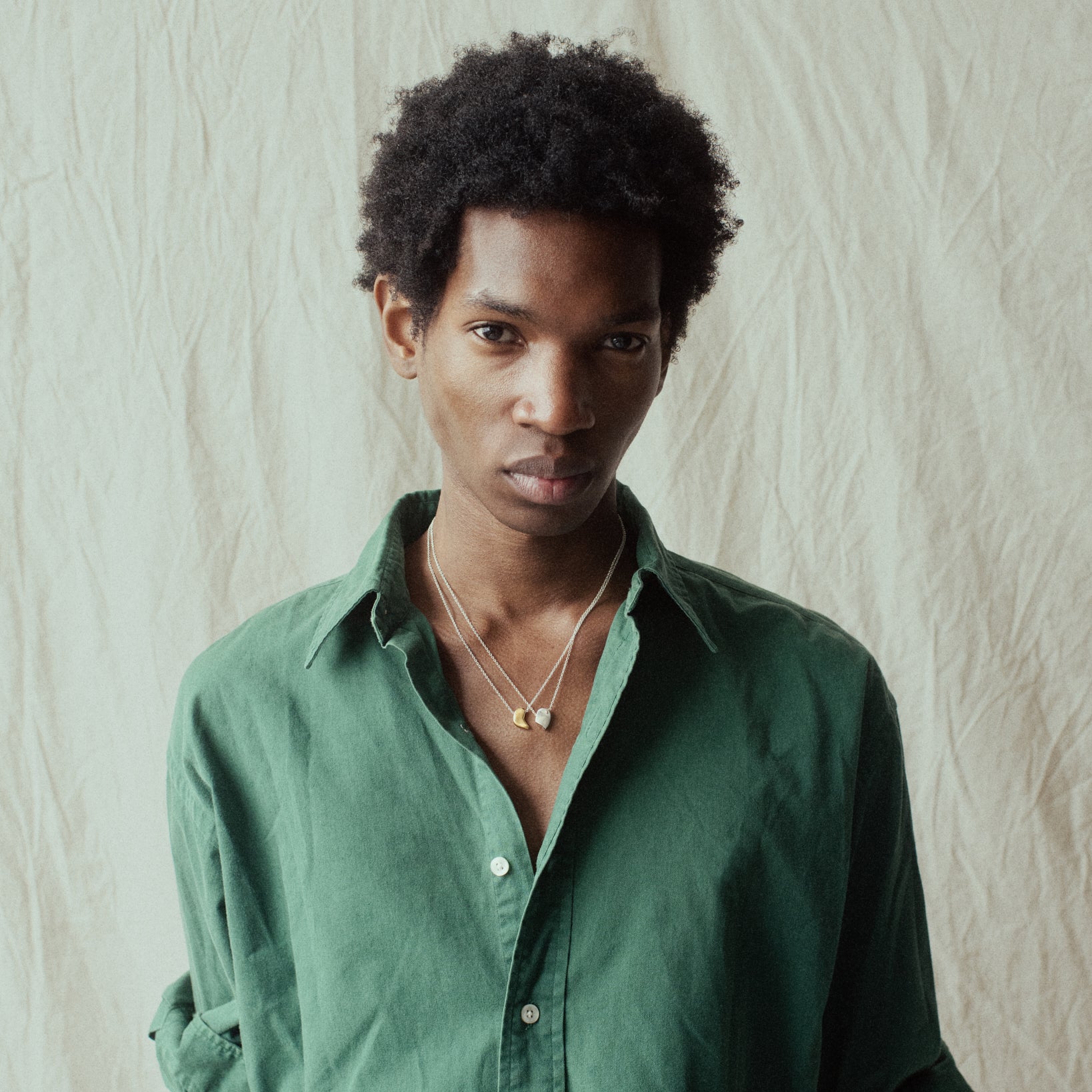 Person wearing AGMES .925 Sterling Silver Sum of Parts Pendant Set with 18K Gold Vermeil Pendant. Modern connecting heart necklace.