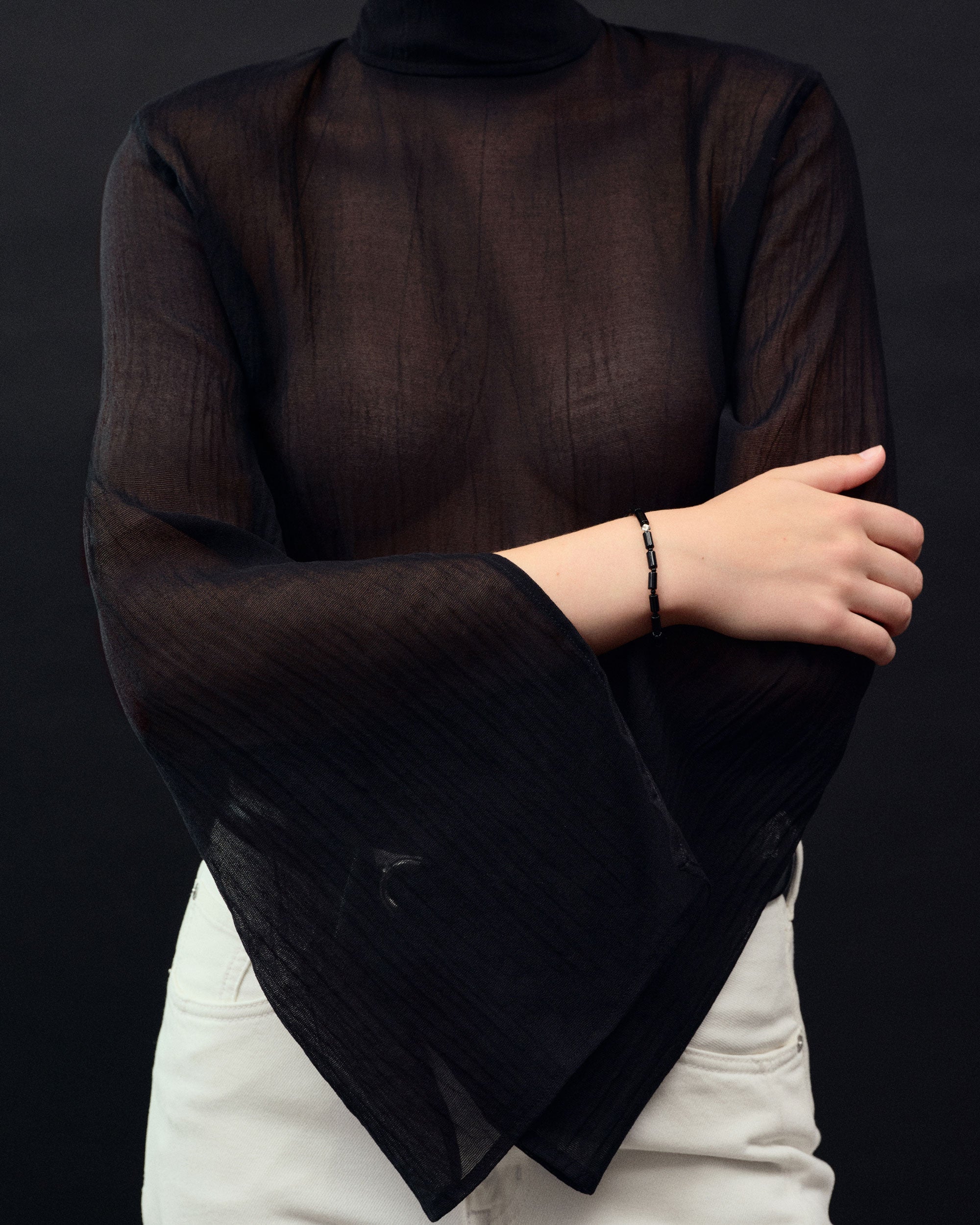 Black onyx beaded bracelet with .925 sterling silver accent on woman's wrist