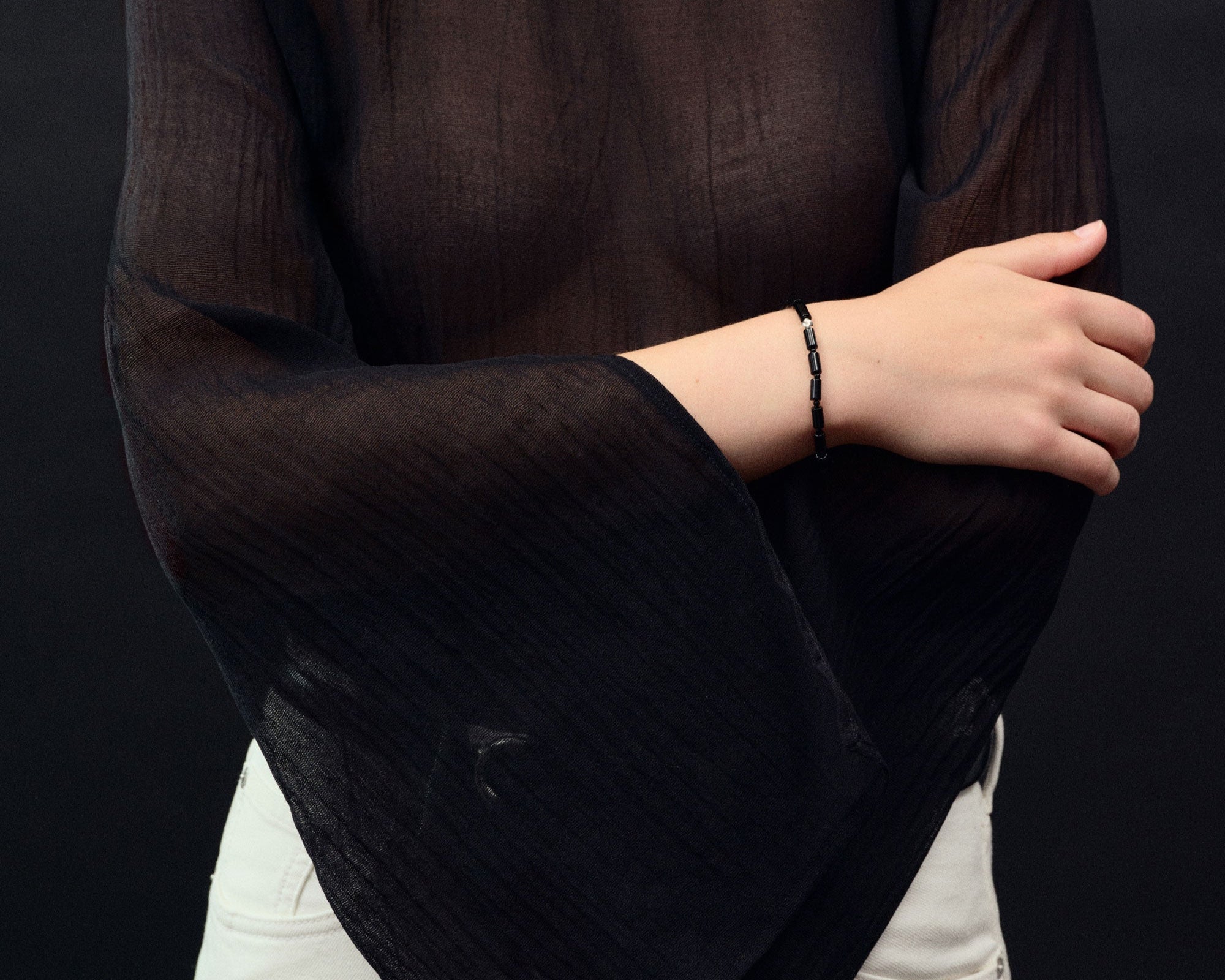 back onyx beaded bracelet with 0.925 sterling silver accent on model's wrist