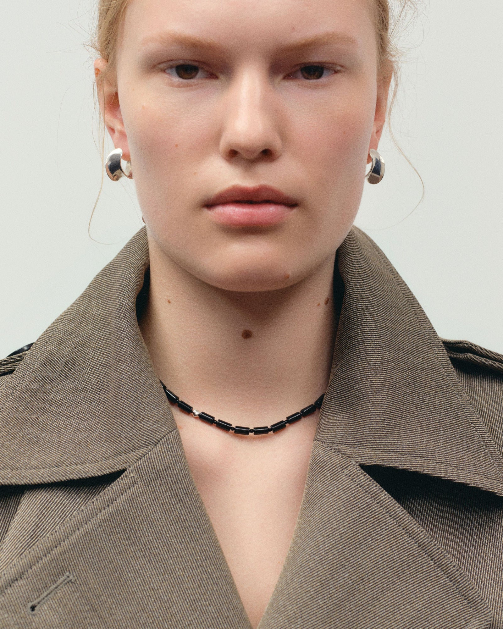 back onyx beaded necklace with 0.925 sterling silver accent on woman's neck