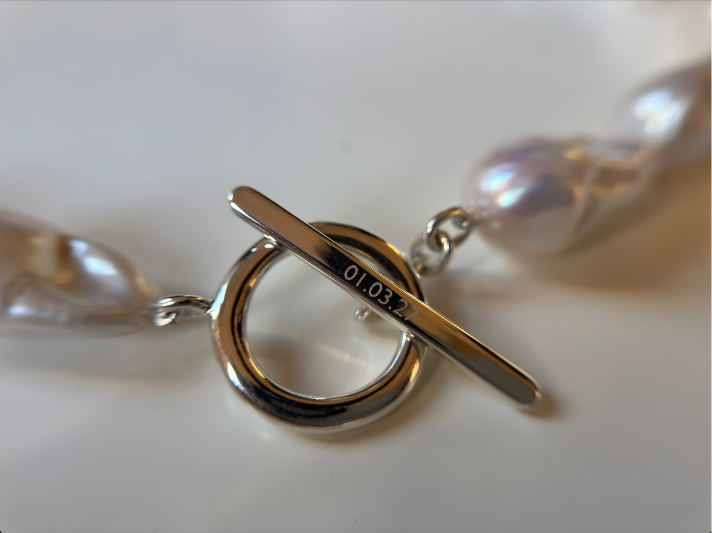AGMES .925 sterling silver Baroque Pearl Necklace Bracelet with engraving on white background.