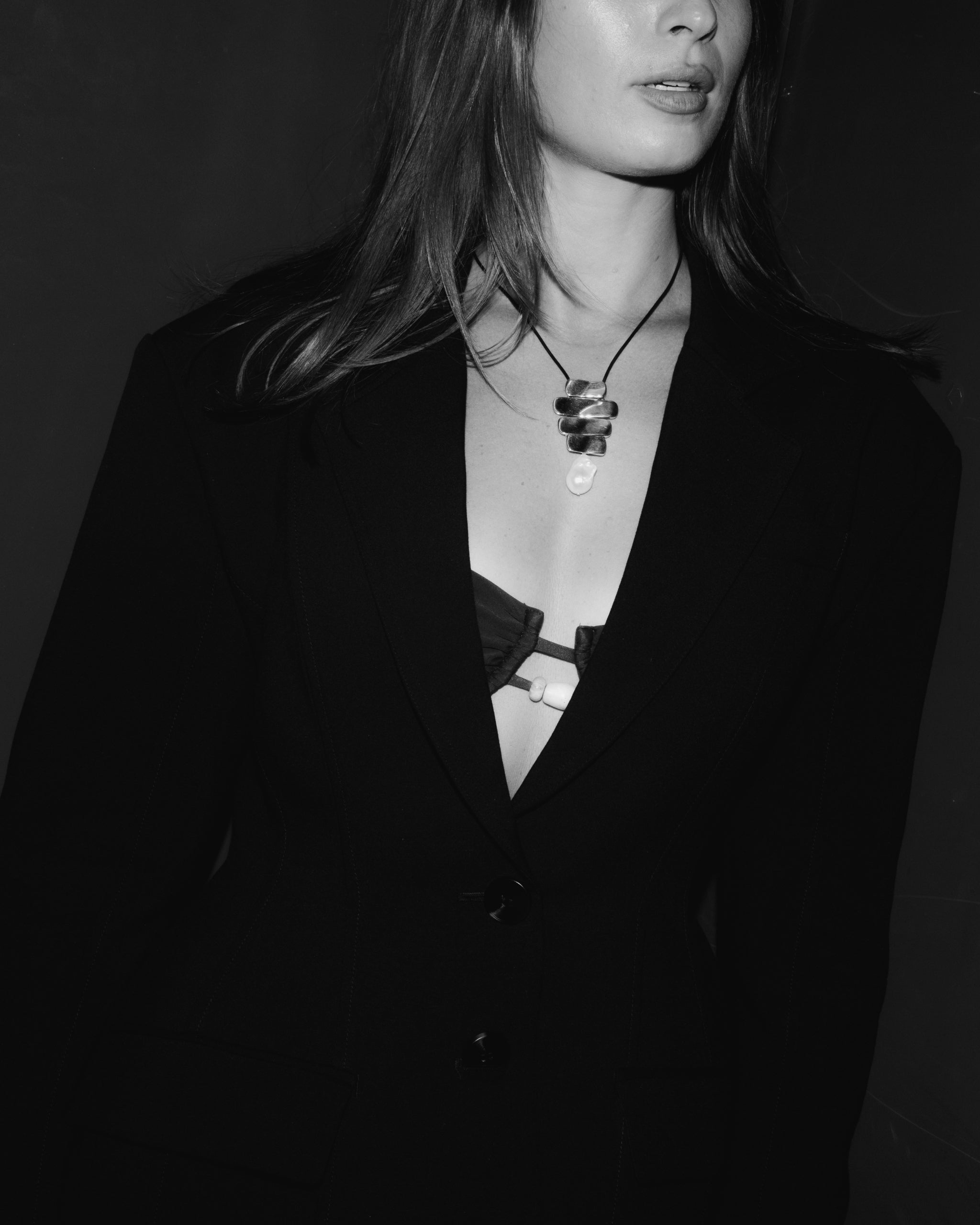 Woman wearing AGMES 925 sterling silver Baroque Ilona Pendant with freshwater pearl drop on black suede cord