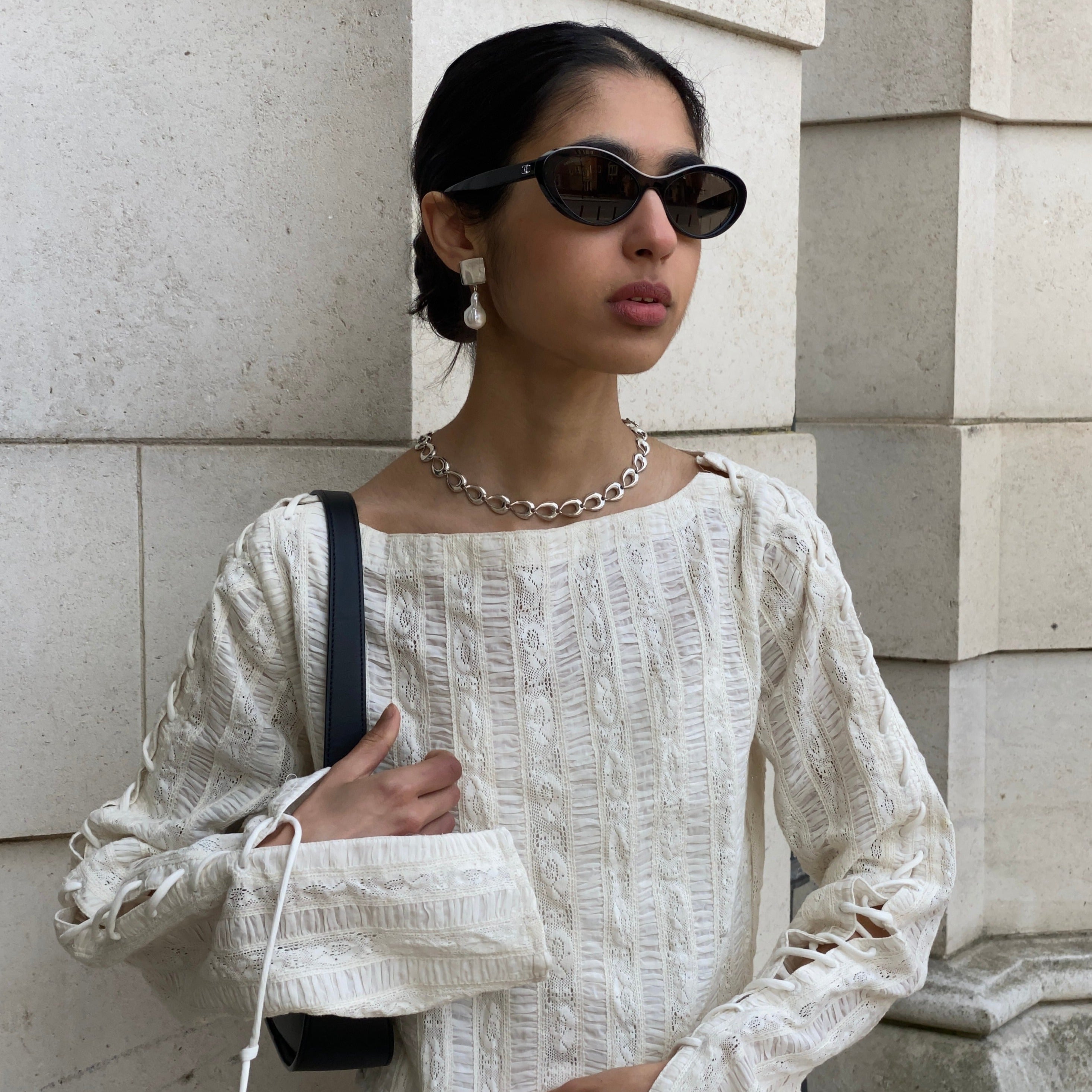 Woman wearing AGMES 0.925 sterling silver square shaped earrings with large baroque freshwater pearl drop.