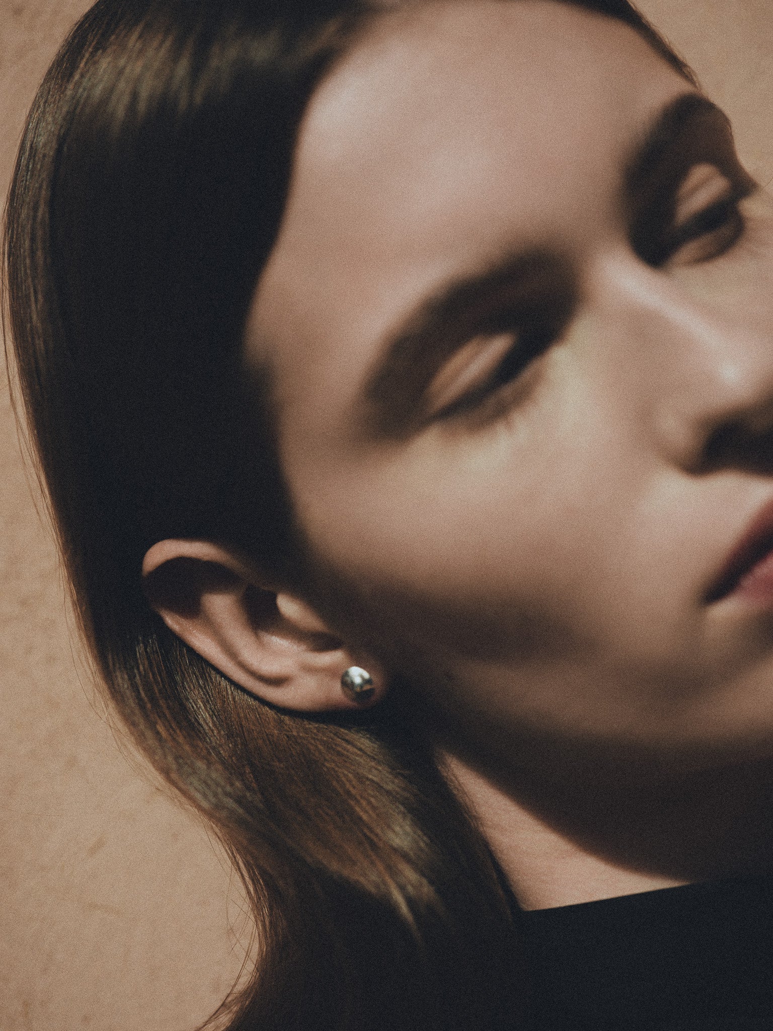 Woman wearing AGMES 0.925 sterling silver round stud earrings.