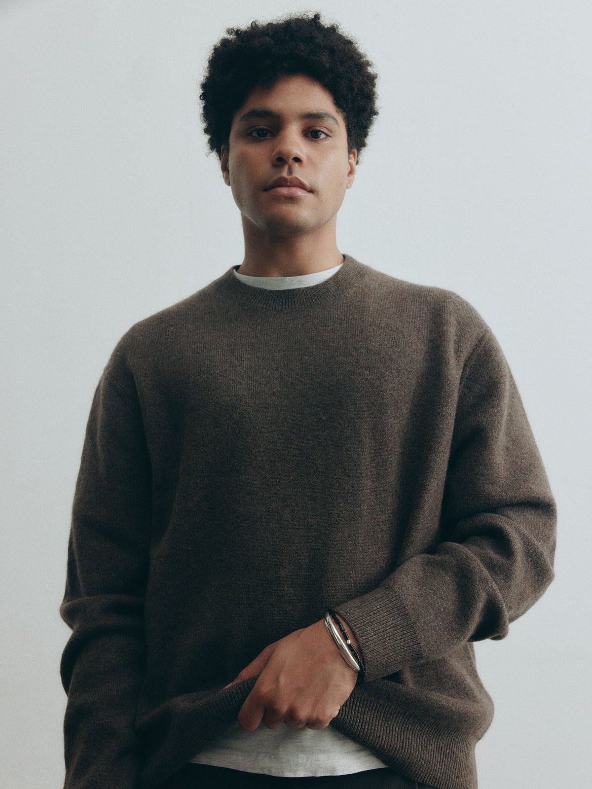 male model wearing AGMES .925 sterling silver AGMES cyril thin cuff bracelet with onyx vallen bracelet