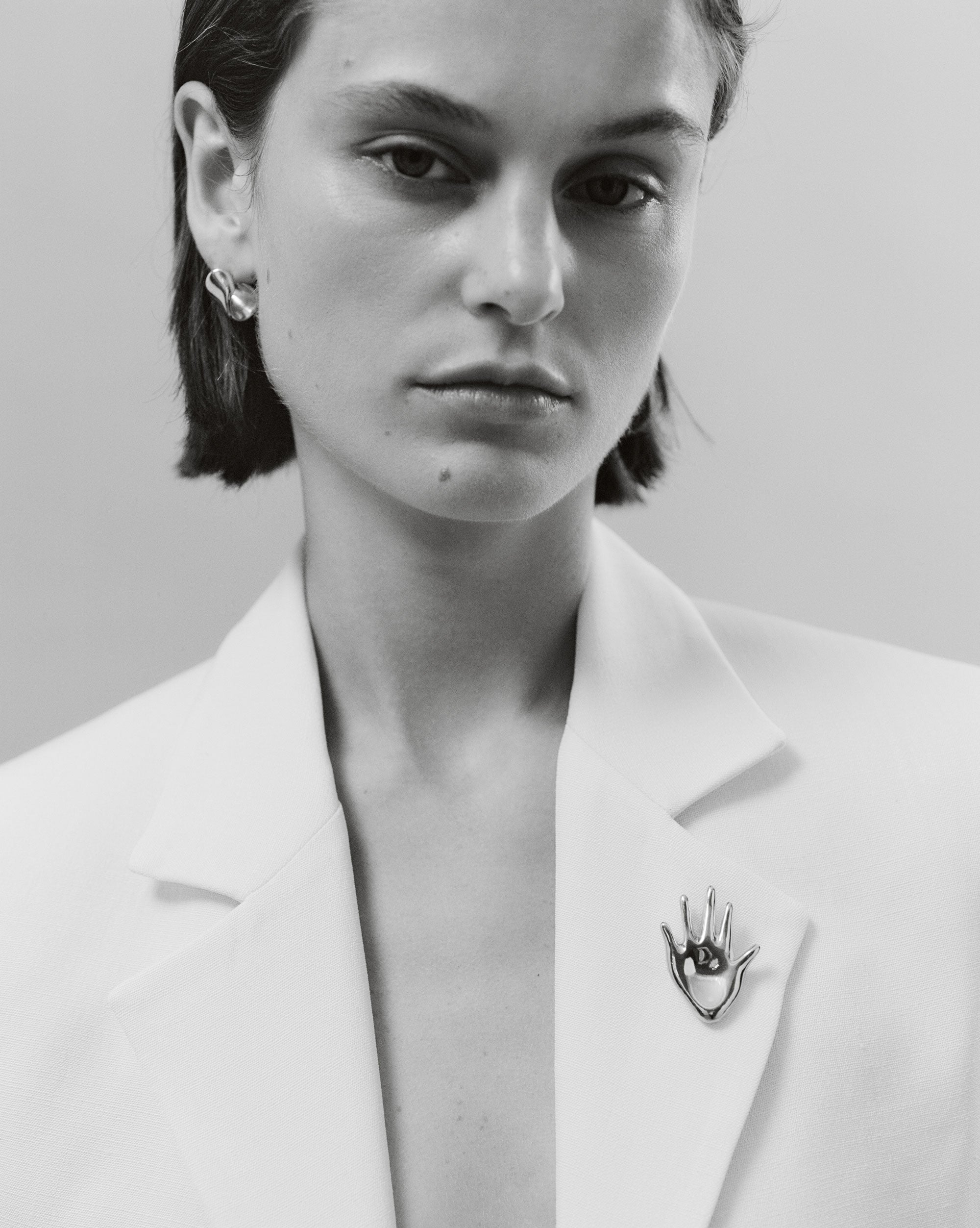 Woman wearing the AGMES .925 Sterling Silver Dali Brooch. Hand shaped Brooch.