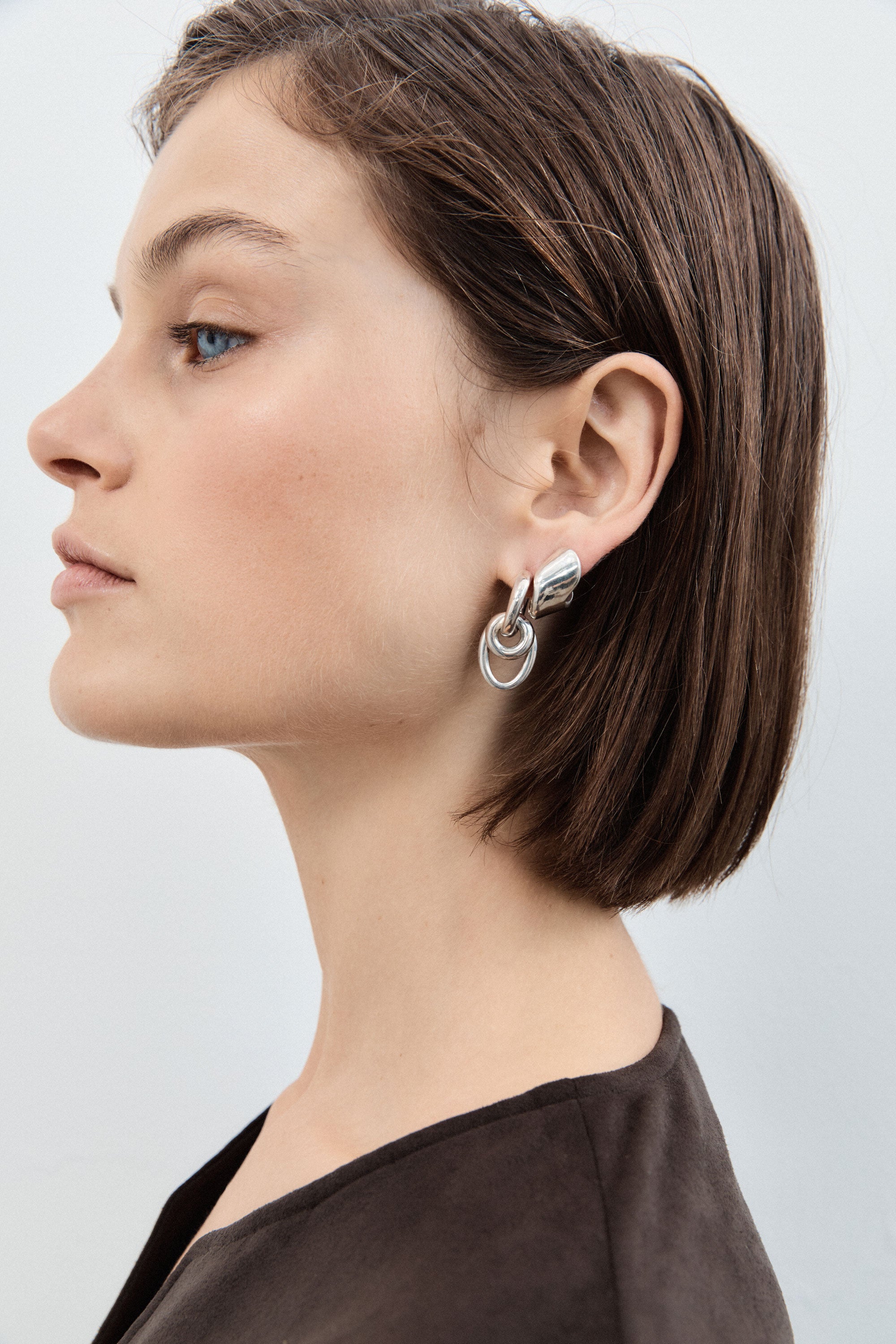 Woman wearing AGMES 0.925 sterling silver double drop hoop earrings.