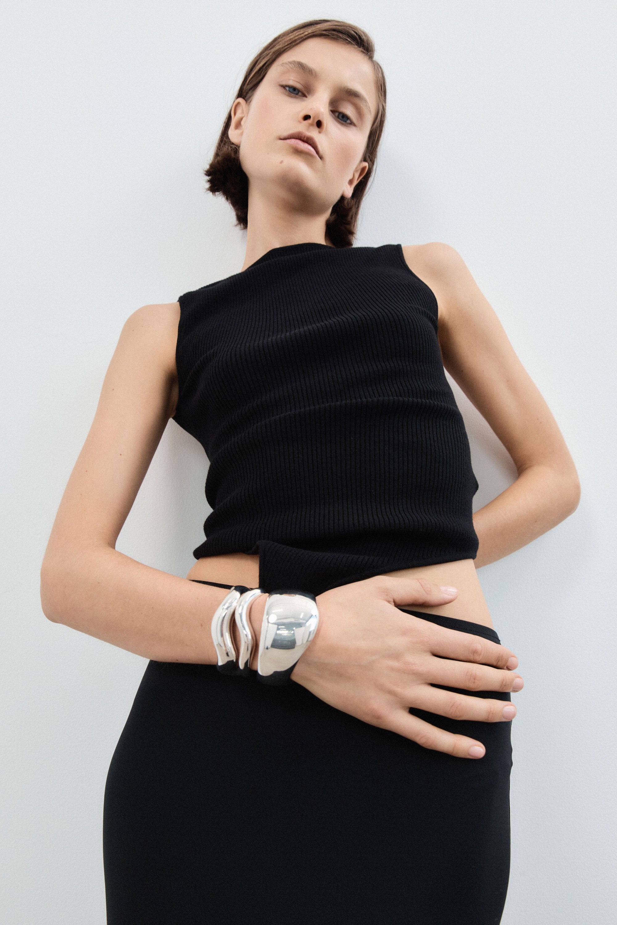 Woman wearing AGMES 0.925 sterling silver curved medium and large astrid cuff bracelet with wide large jean cuff