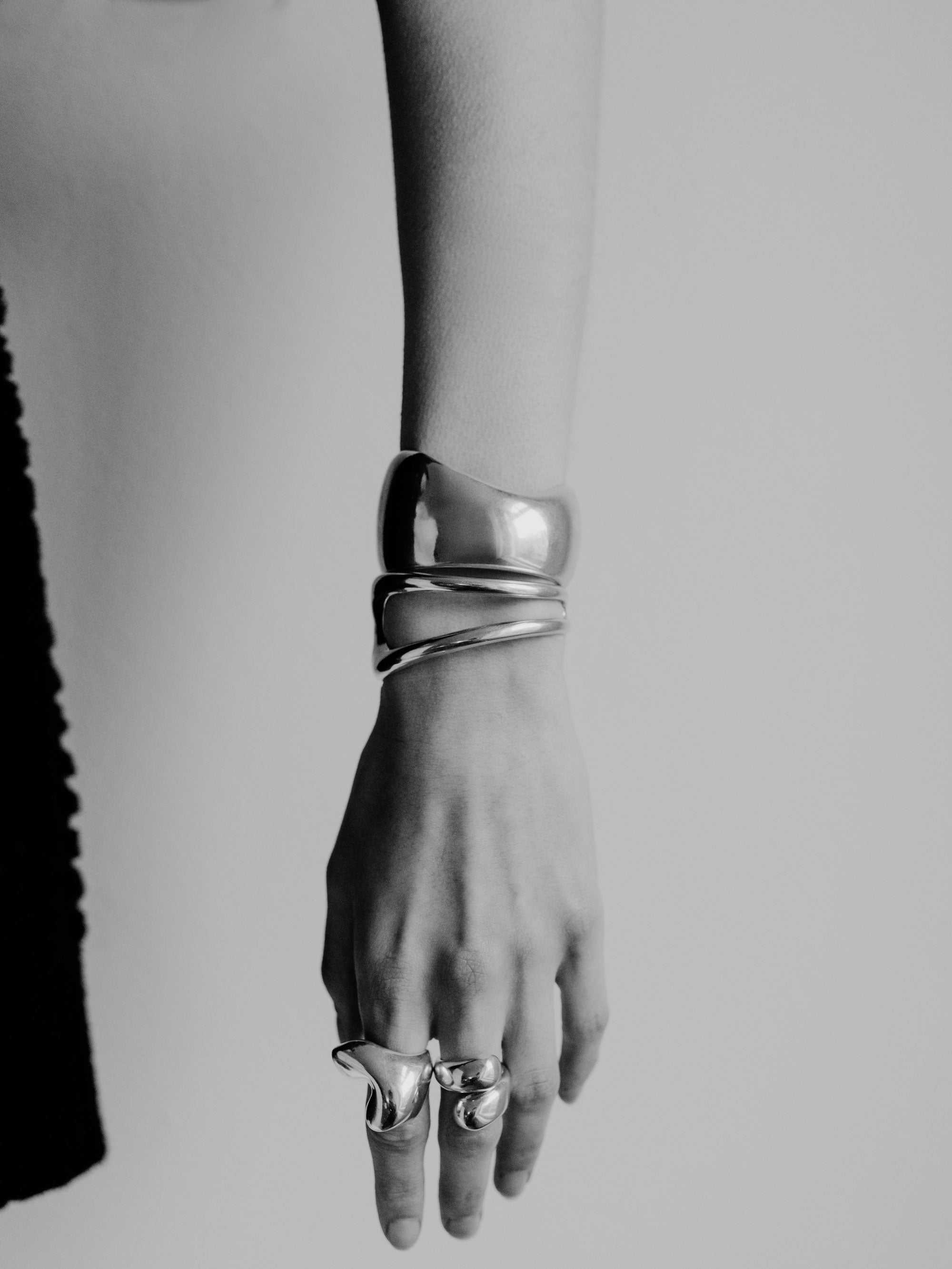 Person wearing AGMES 0.925 sterling silver sculpted abstract cuff set.