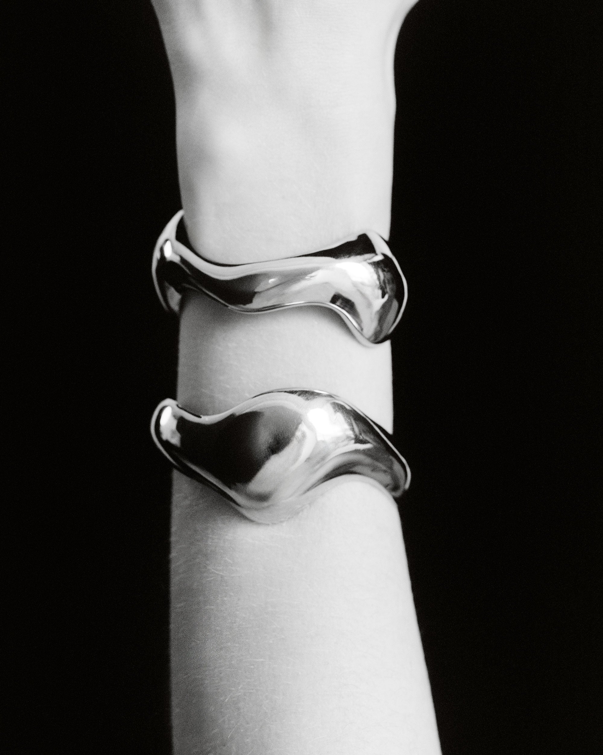 Person wearing AGMES 0.925 sterling silver sculpted abstract cuff set.