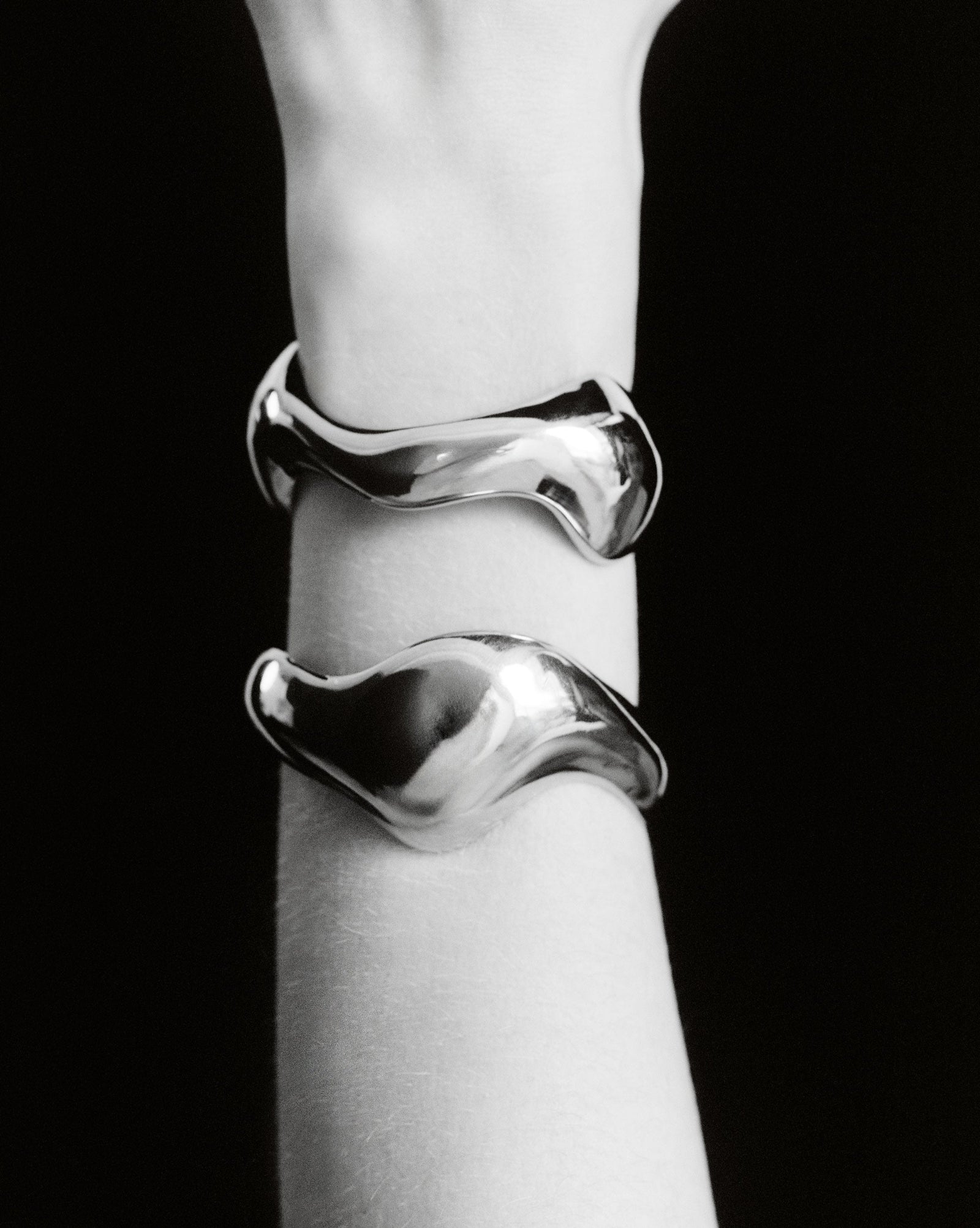 Person wearing AGMES 0.925 sterling silver sculpted abstract cuff set.