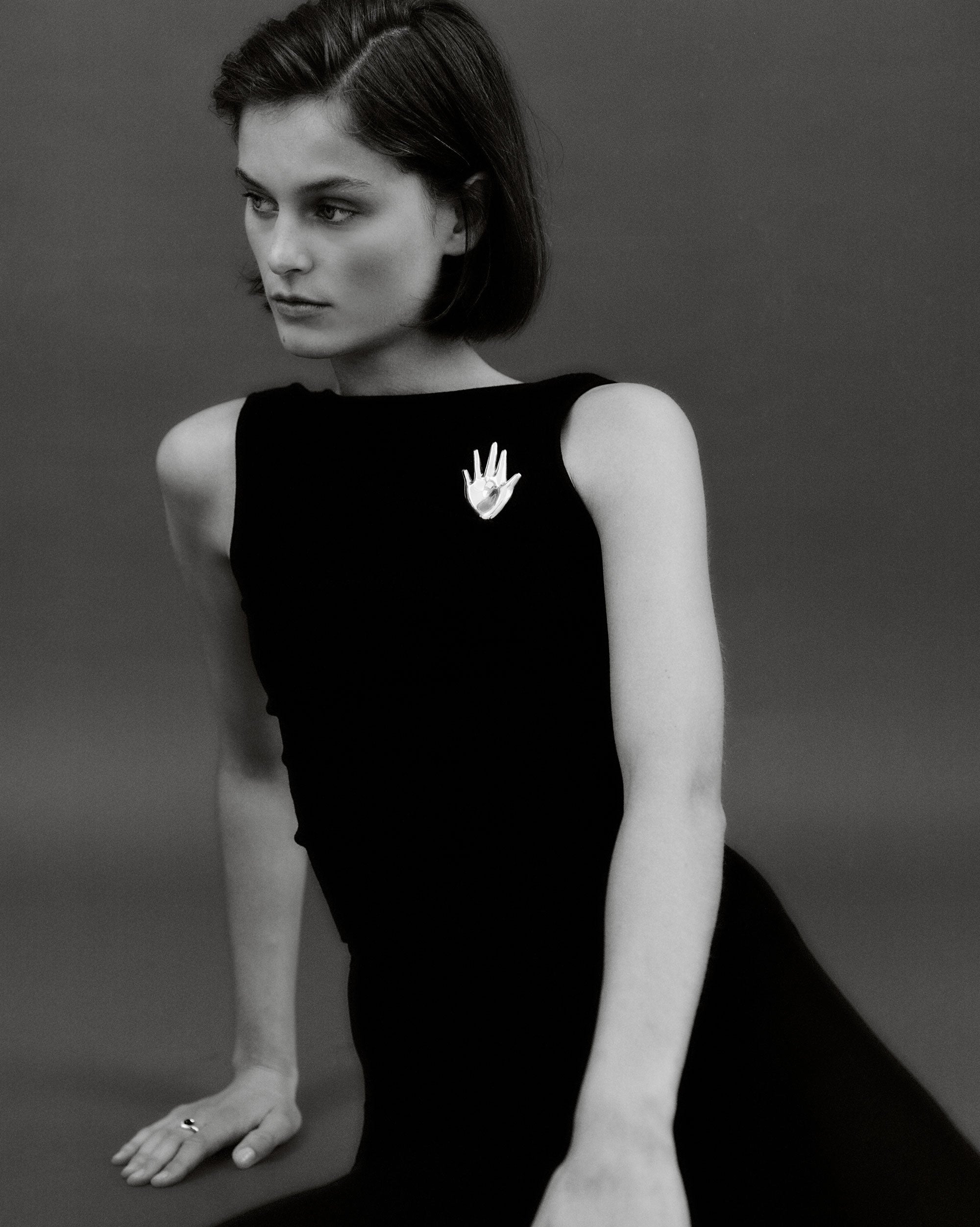 Woman wearing the AGMES .925 Sterling Silver Large Dali Brooch. Hand shaped Brooch.