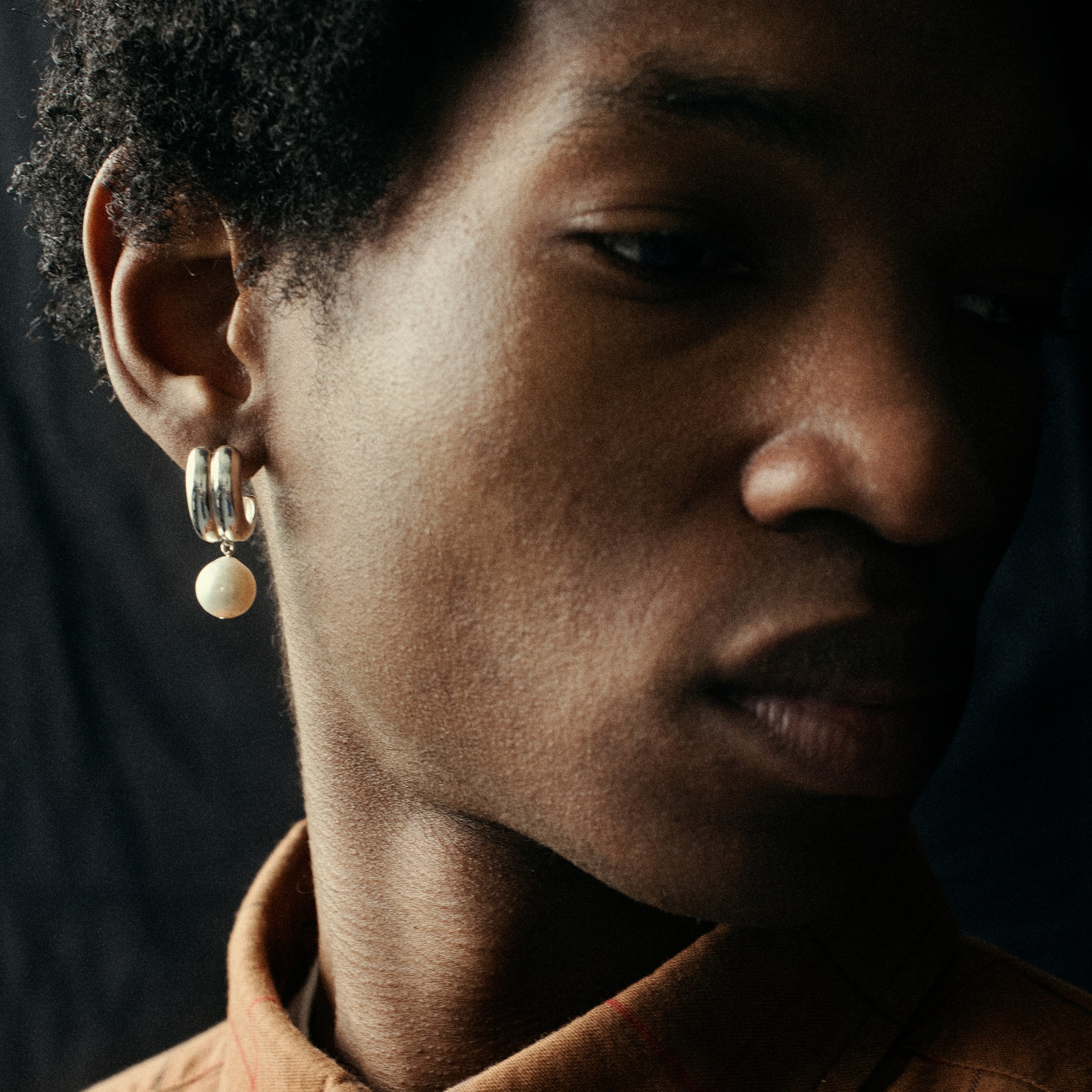 Person wearing AGMES 0.925 sterling silver double ridge earrings with freshwater pearl drop.