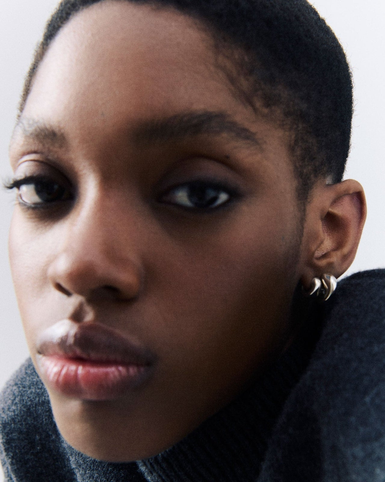 Model wearing .925 sterling silver AGMES Small Dahlia Hoops and Mini Dahlia Huggies