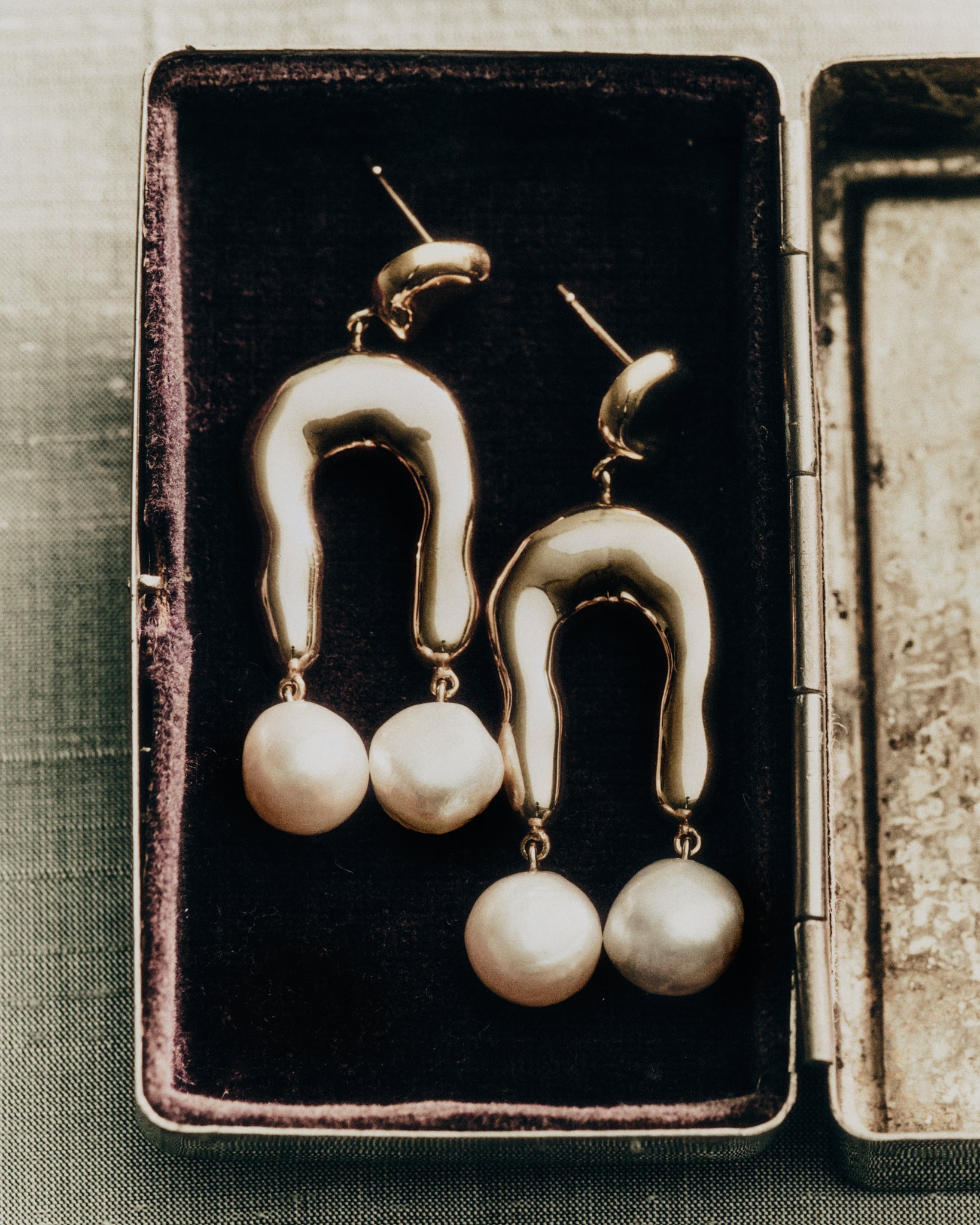 AGMES 18k gold vermeil earrings with sculpted wishbone and freshwater pearl drop.