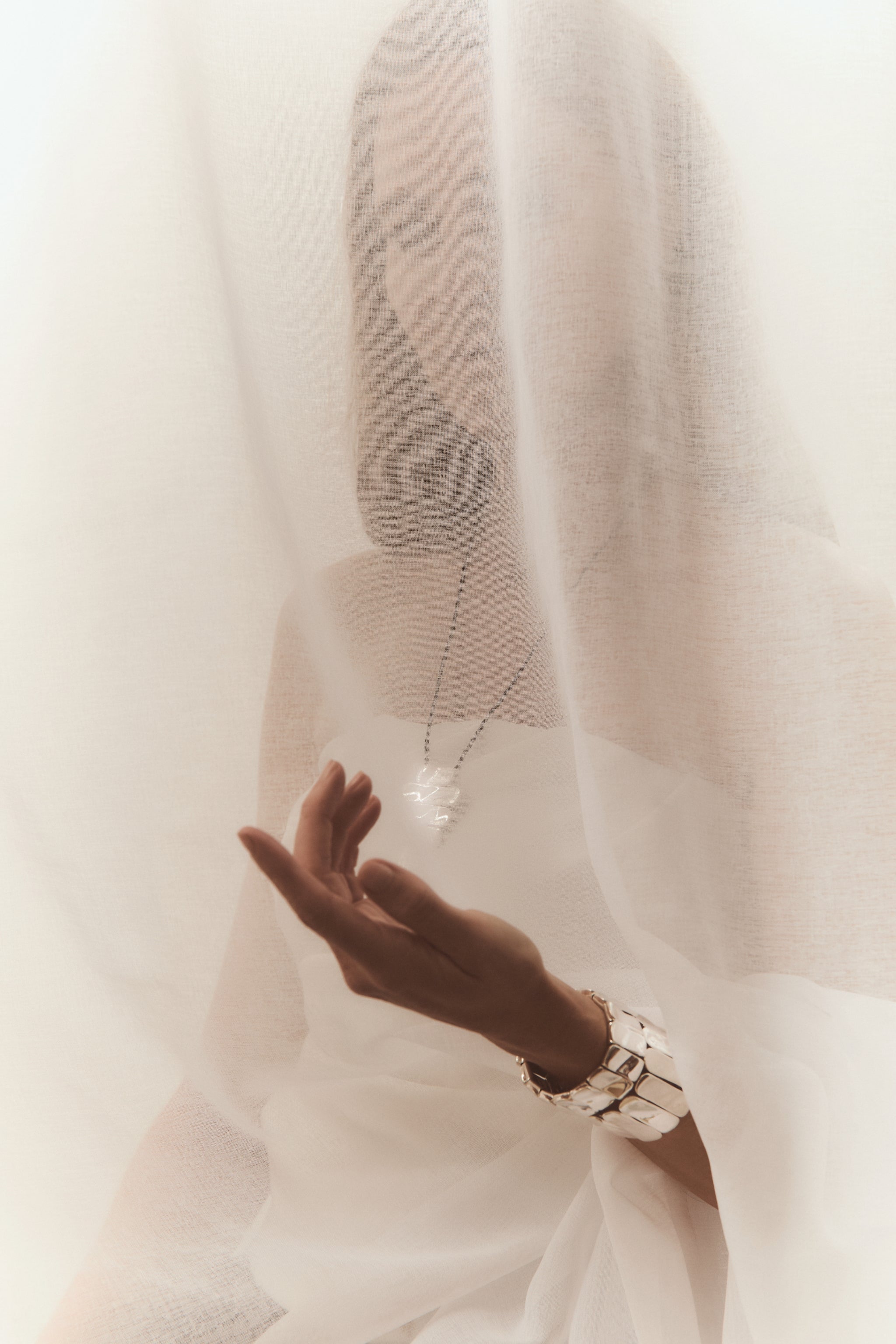 Woman wearing AGMES 0.925 sterling silver Ilona Bracelet with adjustable elastic band.