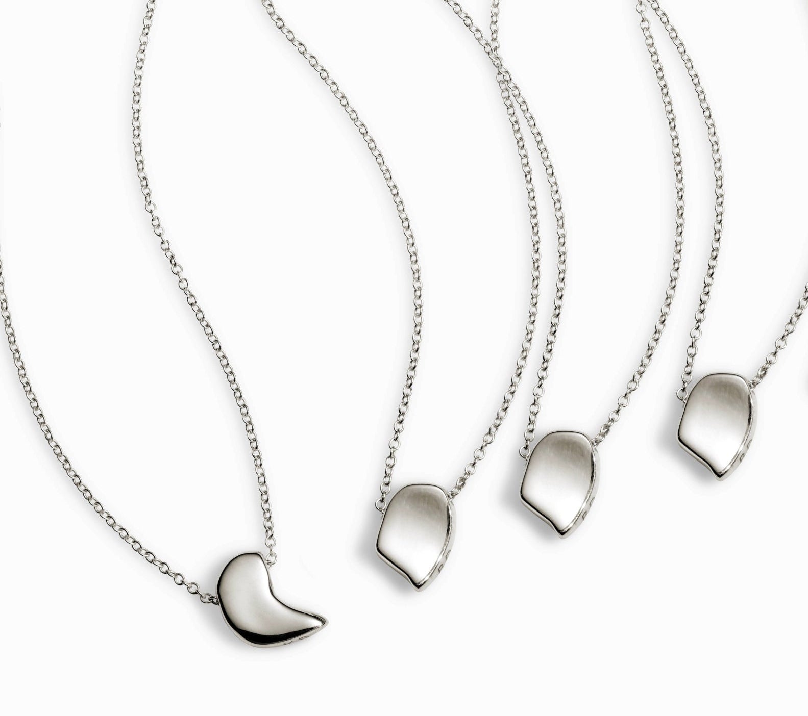 Four AGMES .925 sterling silver sculptural sum of parts pendant necklaces. On white background.