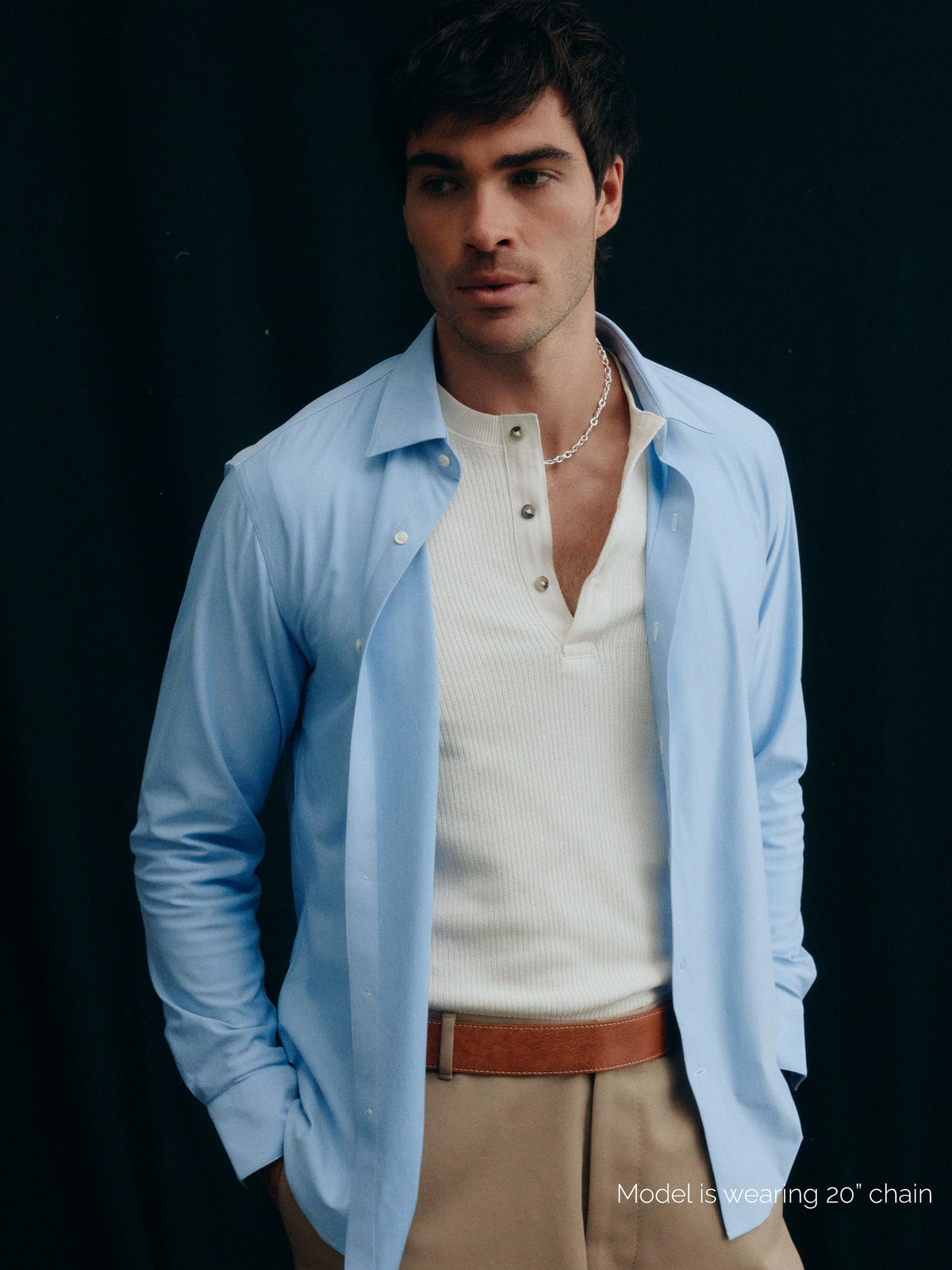 Model wearing AGMES .925 sterling silver 20 inch mixed rope Theo Chain Necklace with sculptural AGMES T-bar clasp with white and blue shirt.