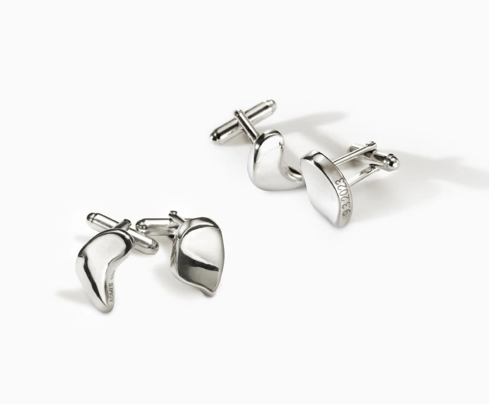 Two pairs of AGMES .925 sterling silver sculptural sum of parts heart cufflinks. On white background.