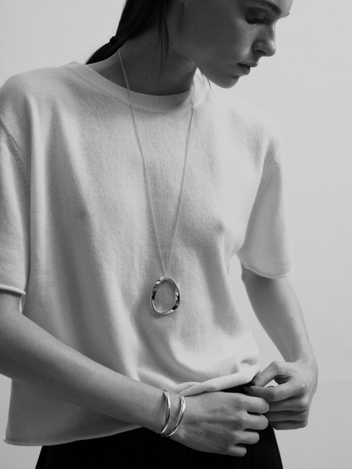 Model wearing .925 sterling silver AGMES isabel pendant and leona cuff