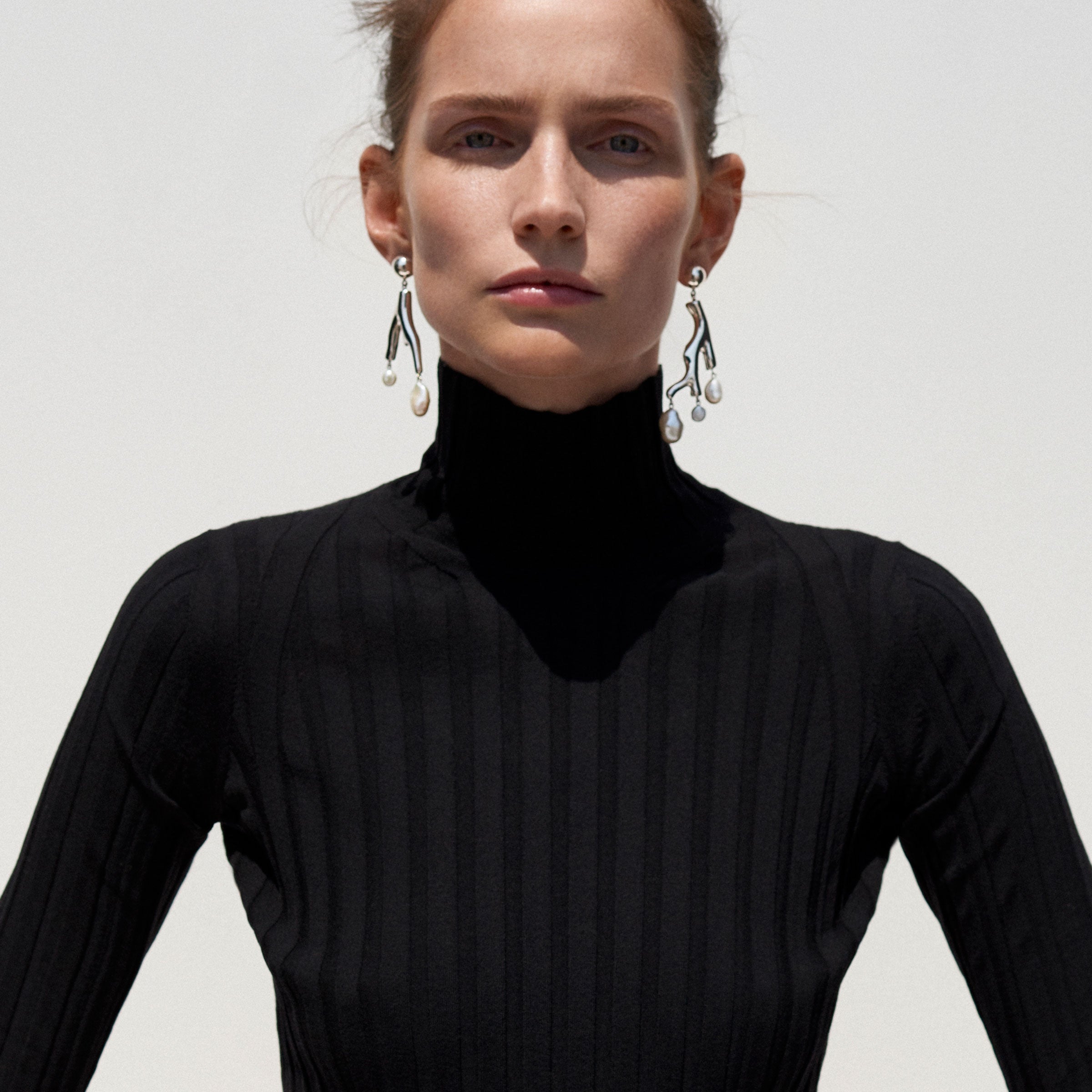 Woman wearing AGMES 0.925 sterling silver coral drop earrings with baroque freshwater pearls.