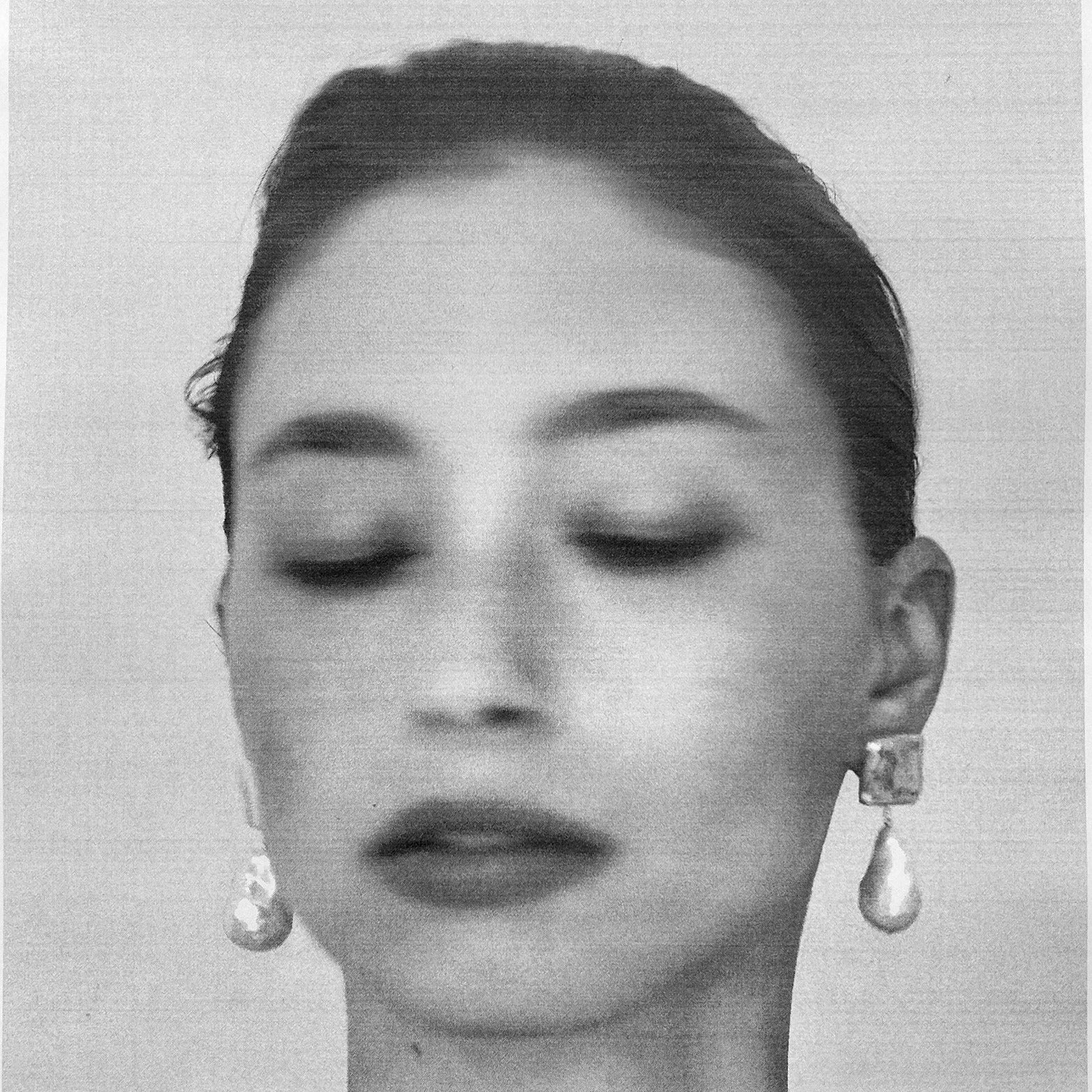 Woman wearing AGMES 0.925 sterling silver square shaped earrings with large baroque freshwater pearl drop.