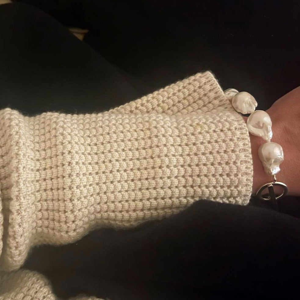 Model wearing AGMES freshwater Baroque Pearl Bracelet with cream sweater.