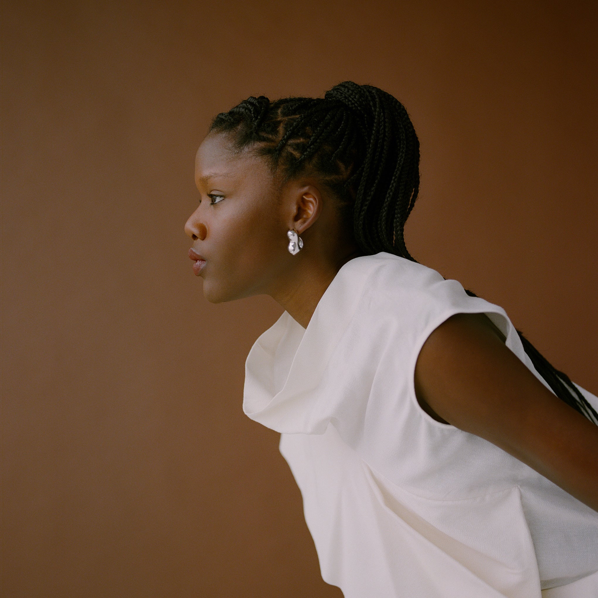 Woman wearing AGMES 0.925 sterling silver sculpted bubble hoop earrings. Simone Bodmer-Turner.