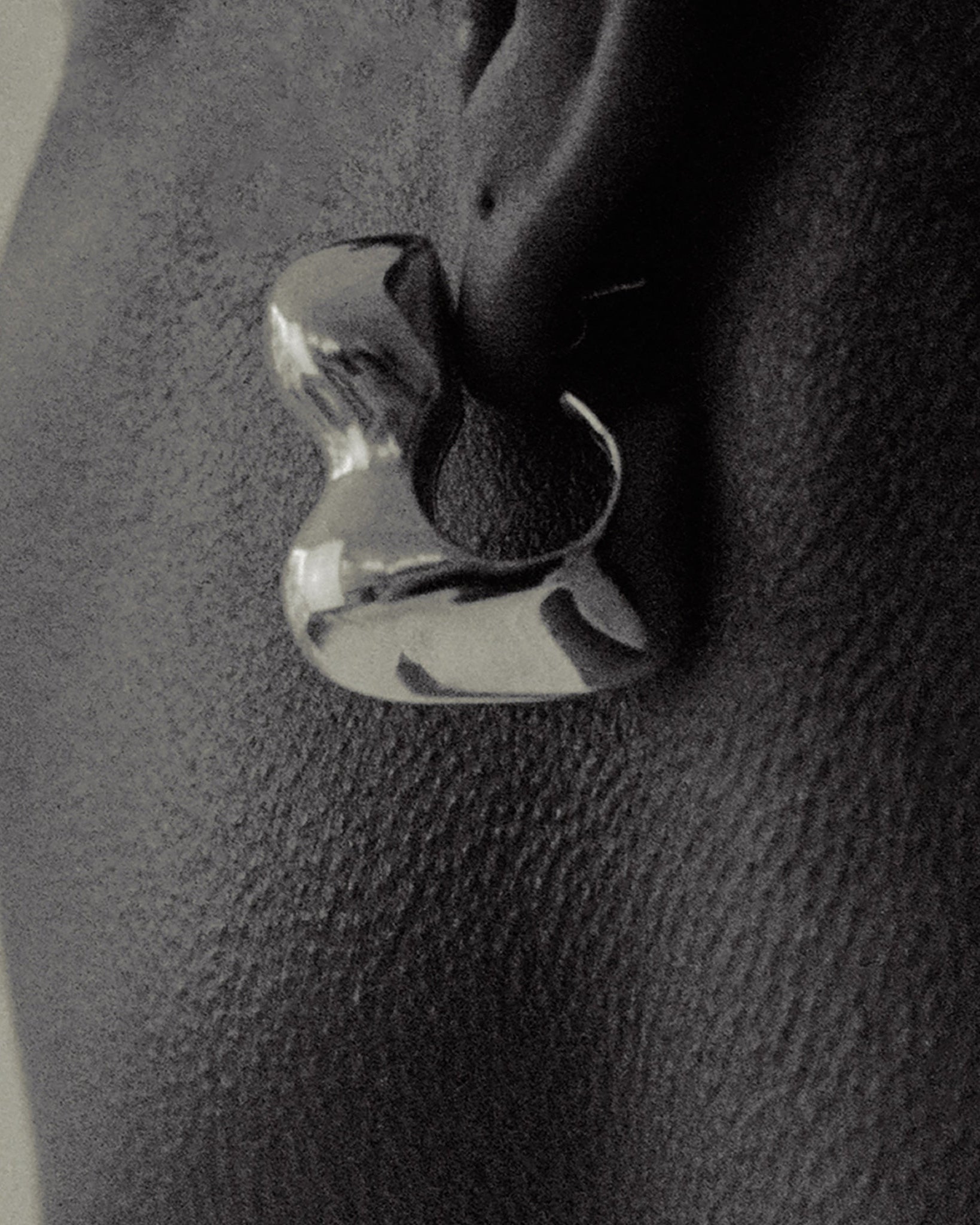 Person wearing AGMES 0.925 sterling silver sculpted bubble hoop earrings. Simone Bodmer-Turner.
